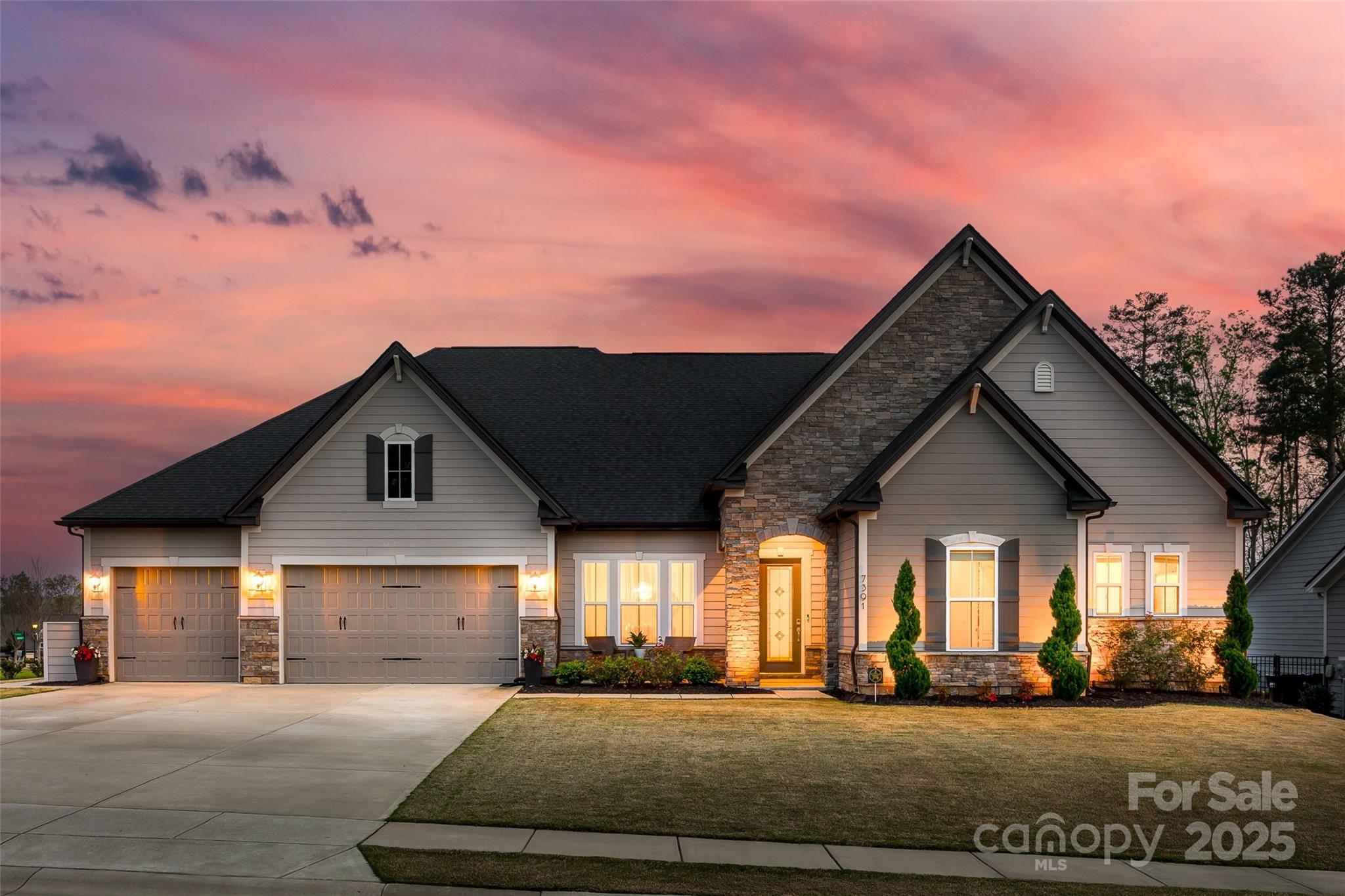 This stunning ranch home offers luxury and comfort with soaring 11-12 foot ceilings and a bright, open floor plan, filled with natural light. The gourmet kitchen features upgraded appliances, 42-inch cabinets, and elegant heavy crown molding and tall baseboards throughout. The large primary en suite serves as a private retreat, along with three additional spacious bedrooms. Step outside to an outdoor fenced in living oasis with a custom in groud, heated, salt water, gunite pool/spa combo perfect for relaxation or entertaining. Pool depth goes from 3 to 6 feet. Just steps outside of the pool you will find the covered outdoor kitchen with a large stone fireplace to keep you warm.  The three-car garage provides plenty of space for vehicles and storage. Located in an area with low SC taxes and award-winning schools, this home combines elegance, functionality, and a high standard of living. Experience the best in luxury living today!