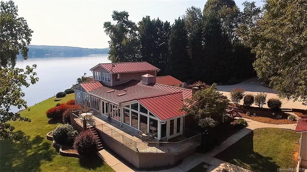 SPECTACULAR WATERFRONT!!! 180 degree views of the main channel on Lake Wylie. In ground pool overlooks the lake with outdoor kitchen and cabana. Open floor plan and spacious kitchen with SS appliances and granite counters. First floor master with great views, gas log fireplace and sun/sitting room. Large first floor recreation room has fireplace and opens to pool. Detached garage has two rooms on second floor with full bath. Dock with boat lift. Lake life minutes from dining/shopping and Uptown.