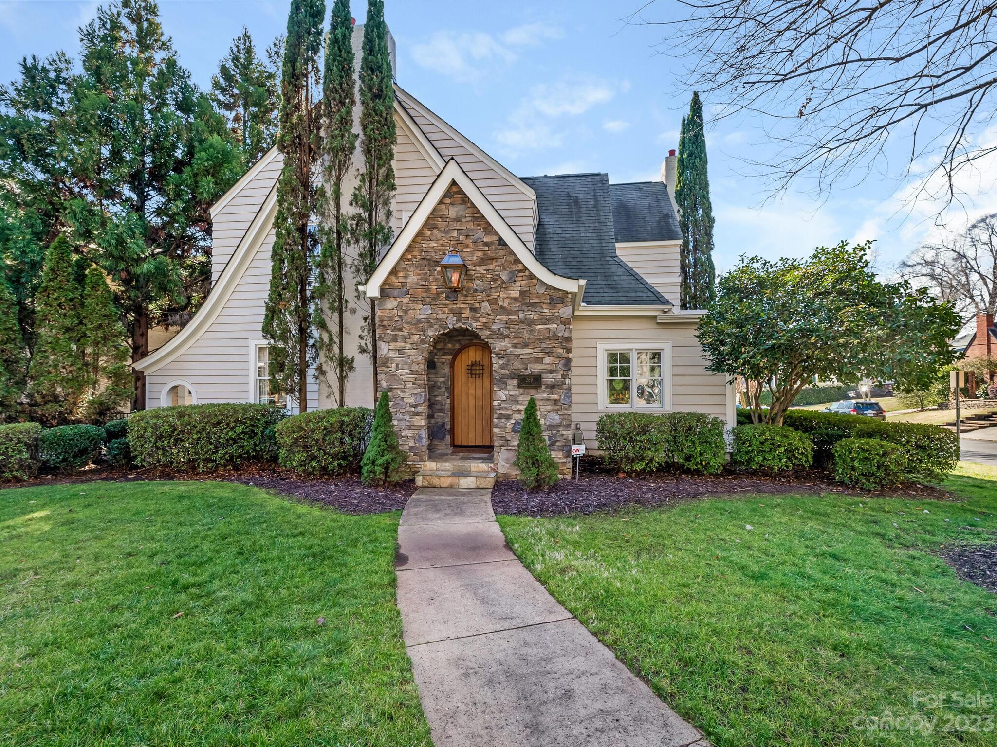 This charming 4 bedroom 4.5 bathroom home is located on a corner lot in highly sought after Myers Park. Renovated while retaining its original character, home boast high ceilings, hardwood floors & lovely moldings. Open floor plan includes a large kitchen w/ island, family room w/ fireplace, wet bar & coffered ceiling. French doors leading to a house length veranda, perfect for entertaining. The primary suite has en suite sitting room w/ custom built-in entertainment center, french doors opening to luxurious bath w/ whirlpool tub, separate shower, large walk-in closet. 2nd floor has 2 other bedrooms w/ original maple wood floors & custom cabinetry. Baths beautifully renovated. 3rd floor offers a bedroom suite w/ bonus room & full bath.The basement is temp controlled, complete w/ gorgeous heart of pine wood flooring & could easily be converted to wine cellar. Professionally landscaped, lawn features mature plants, 1 car garage & circular driveway. Close to greenway, shops & restaurants.