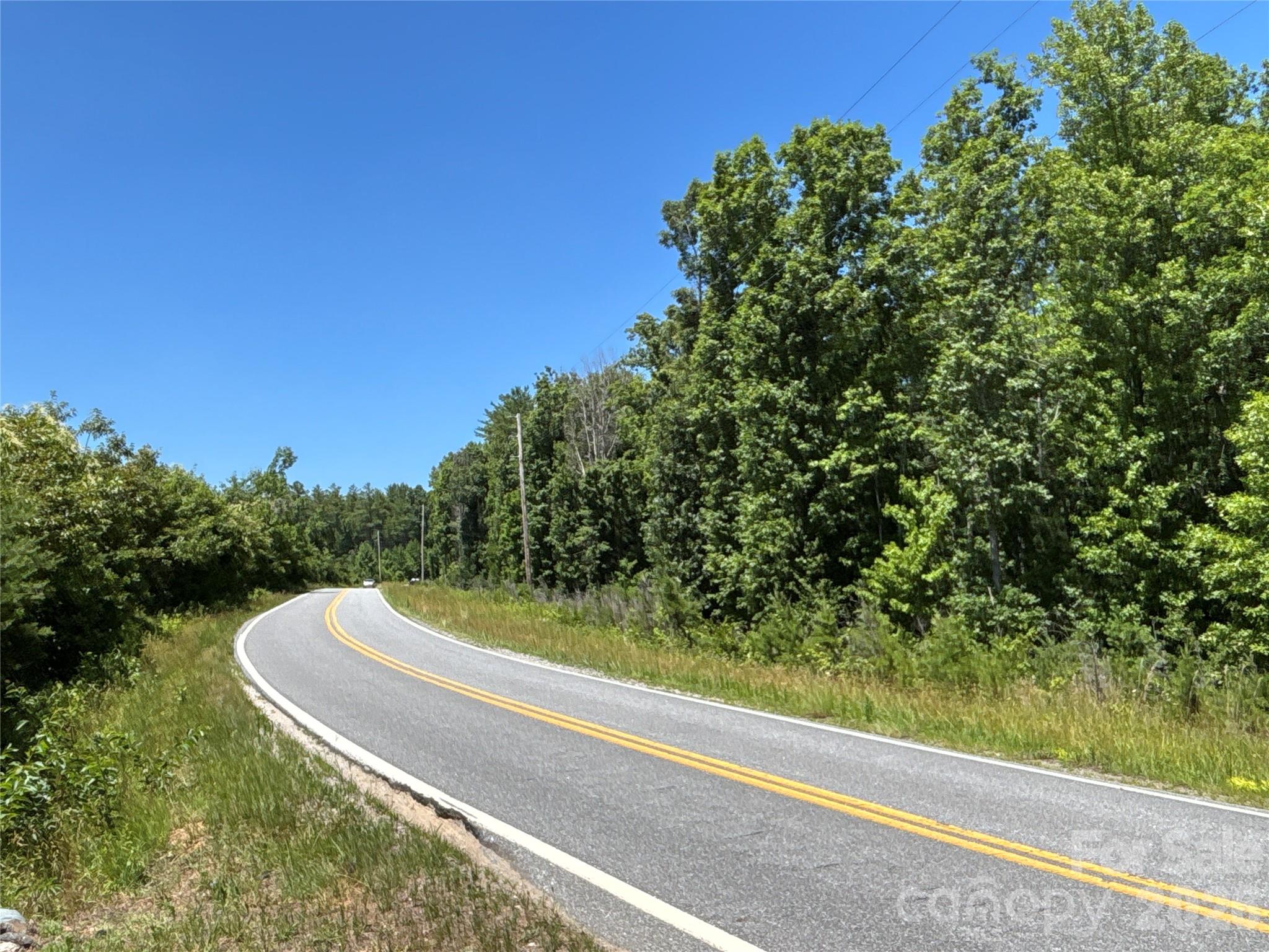 Build your new home on this residential lot located on Piedmont Road in Morganton, NC. Situated at the base of the Appalachian Mountains, this property offers utility access and natural features that complement a variety of site-built home plans. The property is also conveniently located just minutes from the scenic Johns River, providing easy access to fishing, kayaking, camping, and other outdoor recreation opportunities.
The property is zoned residential and is subject to recorded deed restrictions requiring site-built (stick-built) homes only. Public water is available through the City of Morganton, overhead power lines are located along the road frontage, and a septic system will be needed since public sewer service is not available. Water is available nearby and is serviced by the town of Morganton.

A small creek flows along the rear of the property. The lot provides an opportunity to build a custom home while enjoying the convenience of being just minutes from shopping, dining,  and other amenities in beautiful Downtown Morganton!