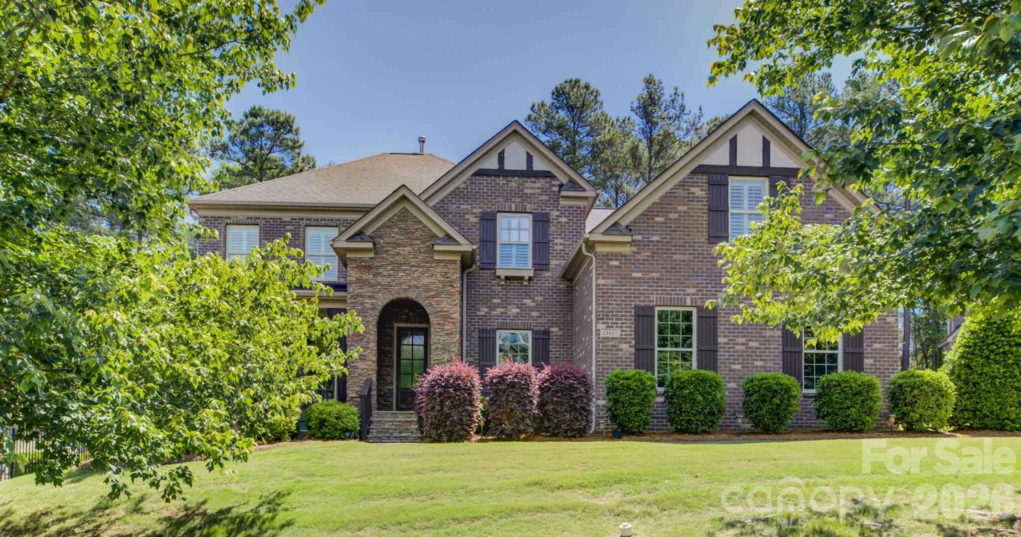 Tucked away on a quiet cul-de-sac in the gated Bear Creek enclave of the amenity-rich Palisades community, this exceptional two-story brick-and-stone residence offers timeless curb appeal and a highly functional floor plan designed for both entertaining and everyday living. Freshly painted ready for new owner. A welcoming foyer is flanked by a private study/living room and an elegant formal dining room accented by classic wainscoting and a tray ceiling. The home flows seamlessly into the gourmet kitchen—complete with abundant cabinetry, granite countertops, a gas cooktop, and a wall oven—while a convenient pass-through butler’s pantry enhances hosting and storage. The breakfast bar opens to a sunlit great room centered around a striking stone fireplace, creating an inviting gathering space. Step outside to a generous deck overlooking a private wooded backdrop—ideal for morning coffee, outdoor dining, or relaxing in a serene setting.The main-level primary suite is a true retreat, featuring plantation shutters, a double tray ceiling, dual vanities, a soaking tub, and a glass-enclosed shower. A well-appointed laundry room with extensive cabinetry adds everyday convenience. Upstairs, secondary bedrooms are thoughtfully arranged for flexibility: bedrooms 2 and 3 share a Jack-and-Jill bath, while an additional bath connects to bedroom 3 and the bonus room/bedroom 4 configuration—perfect for guests, recreation, hobbies, or work-from-home needs. The oversized bonus room provides excellent versatility and can easily serve as a media space, playroom, or a secondary living area.Residents enjoy access to impressive community amenities, including a clubhouse, outdoor pool, fitness center, playground, pickleball and basketball courts, and walking trails, with optional golf and social memberships available through the award-winning Palisades Country Club.