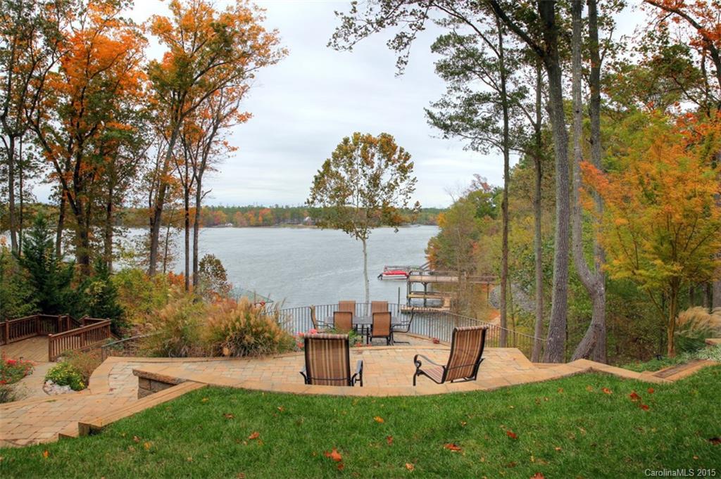 WOW! Panoramic VIEWS from most every room in this beautiful CUSTOM built home on Lake Wylie! Outdoor living at it's finest with boat dock, porches, patios and even your own sandy BEACH! Gorgeous home has master suite on  main level. FANTASTIC open floor plan for entertaining with elegant finishes throughout the home. HUGE lower level opens up to covered porch.  Located on a QUIET deep water cove in an upscale neighborhood, this is a must see! AWARD winning Clover schools; close to Charlotte!