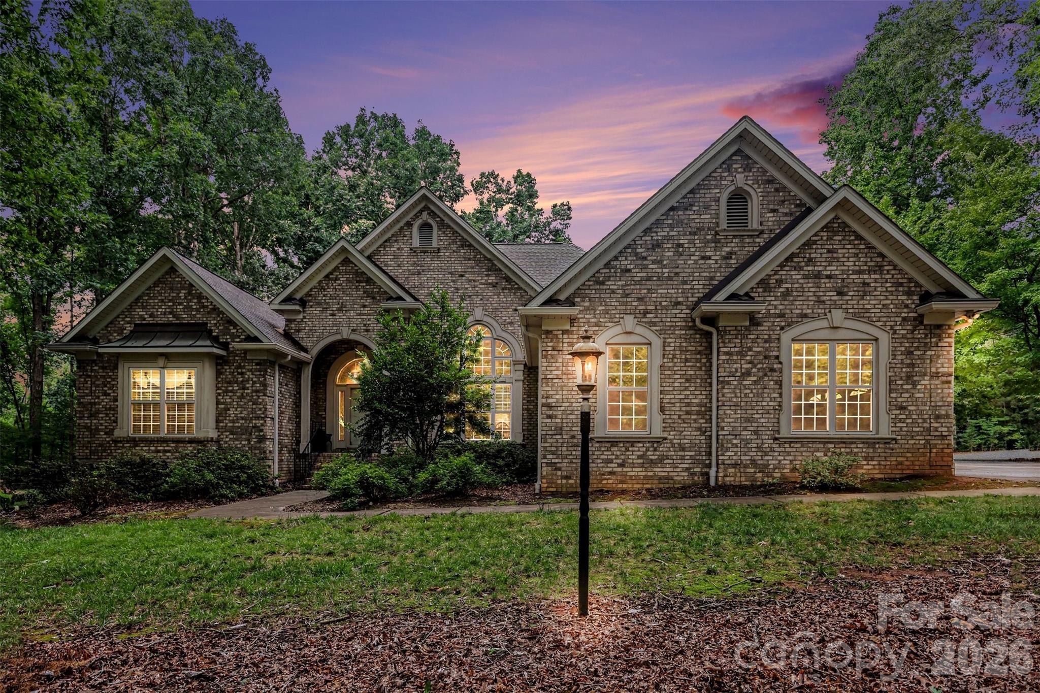 A unique estate property where thoughtful updates, quality craftsmanship, outstanding outdoor living areas, and unmatched versatility come together in this custom built home on approximately five private acres The all-brick home features an open, split-bedroom floor plan with beautiful hickory flooring, gas log fireplace in the den and setting for electric fireplace in the spacious living room, and a beautifully remodeled kitchen with leathered granite countertops, cherry cabinets, and high-end appliances. Recent improvements include a 2023 architectural roof, updated HVAC systems, and a deluxe water treatment system. An oversized walk-up attic provides exceptional storage. Outside, enjoy peaceful mornings on the screened porch, afternoons by the saltwater pool, and evenings entertaining beneath the covered pavilion. The impressive detached garage/workshop offers three oversized bays, an attached tall carport ideal for RV or large vehicle storage, abundant parking, and a heated and cooled flex space with a full bath and kitchenette—perfect for a workshop, office, recreation room, man-cave, she-shed, or countless other possibilities. Offering privacy, functionality, and room to pursue almost any passion, this exceptional property feels worlds away while remaining just minutes from Concord's shopping, dining, and everyday conveniences. A detailed feature sheet highlighting the home's many upgrades and amenities is available.