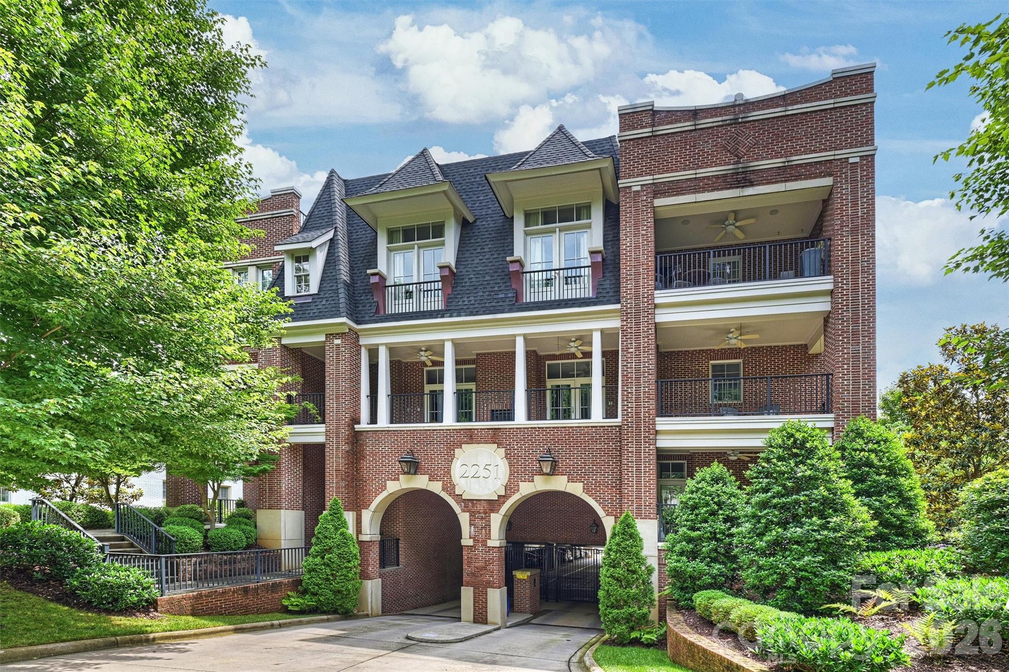 Experience  living in the heart of Myers Park at 2251 Selwyn Avenue, ideally located within walking distance of shops, restaurants, Queens University, and Freedom Park.

This exceptionally quiet first-floor residence welcomes you with a spacious foyer and an open-concept floor plan designed for comfortable living and entertaining. The dining room features a charming niche perfect for displaying artwork or accent furniture and flows seamlessly into the generously sized family room. French doors flank the fireplace and open to a private covered porch, creating an inviting indoor-outdoor living experience.

The chef's kitchen is beautifully appointed with a gas cooktop, double ovens, a microwave drawer, abundant white cabinetry, classic marble countertops, and a large island with breakfast-bar seating. Additional storage is provided by a walk-in pantry and an oversized laundry room.

The thoughtfully designed split-bedroom floor plan offers privacy for both owners and guests. The primary suite features two custom walk-in closets and a spa-inspired bath complete with a freestanding soaking tub. Each secondary bedroom includes its own en-suite bath, while a separate powder room serves guests.

Easy in, easy out secure parking garage which is quite large with abundant spaces. The property has three deeded parking spaces, two of which are covered. Dog owners will appreciate the fenced pet area adjacent to the garage, along with a gated sidewalk providing easy access along the side of the building if pets don't like the elevator. 

Additional community amenities include a covered second-floor porch for residents to enjoy.

This exceptional home combines luxury, convenience, and walkability in one of Charlotte's most desirable neighborhoods.