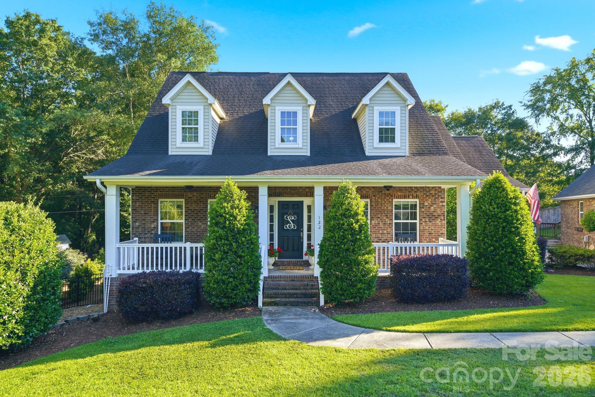 If you've been searching for a little more space, a little more privacy, and a lot less HOA hassle, this one is worth a look. Nestled on a quiet cul-de-sac in Fort Mill's quaint Friendfield neighborhood, this custom-built home sits on a large private lot surrounded by mature landscaping and room to breathe.

Inside, you'll find beautiful updated site-finished hardwood floors throughout the main living areas, a stylish modern kitchen, and a comfortable floor plan with 3 bedrooms and 2.5 baths. The primary suite is conveniently located on the main level, offering privacy and easy everyday living.

Out back is where this home really shines. Enjoy summer days by the saltwater pool, unwind on the screened porch, or entertain friends in your own backyard retreat.

Need extra space? The detached two-car garage features a temperature-controlled flex room above that's perfect for a home office, gym, playroom, guest space, or whatever fits your lifestyle.

Located just minutes from Fort Mill Golf Club, shopping, dining, and Fort Mill's award-winning schools, this is the kind of property that rarely comes along—custom-built, primary suite on the main floor, large lot, no HOA, and plenty of room to enjoy life.
