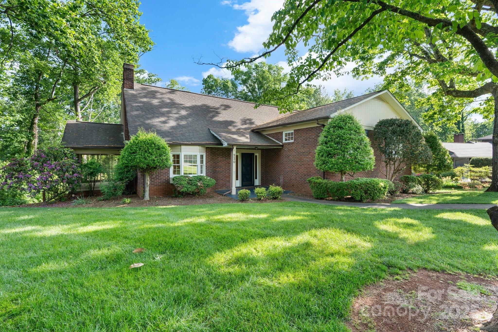 This warm & inviting home offers character & charm in downtown Morganton! Thoughtfully situated and set back on the 0.8 acre lot, the home boasts a large level front yard. Step inside to a spacious foyer. In the large living room, you'll find a charming bay window bathing the room in natural light and a fireplace. Off the living room is a screened porch. The main floor also includes a dining room and eat-in kitchen. Upstairs are two bedrooms and an updated hall bathroom plus a 3rd bedroom with en suite updated bath. The large primary suite occupies the entire top level of the home with built-ins and a large en suite bathroom with jetted tub. The basement has a large finished room with exterior entry perfect for an additional living space, office, or studio. Storage abounds in the unfinished basement area. Whether you're enjoying the large back deck or entertaining in the private backyard, this home offers a mix of classic craftsmanship and downtown living. A true Morganton gem!