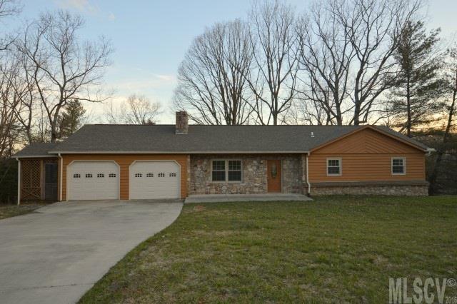 Beautiful 3 bedroom, 3 bath home has had numerous updates. New in mid 2014 are the roof, heat pump, windows, custom built oak cabinetry, granite countertops, hardwood flooring in the living room and hall, porcelain tile flooring in kitchen and baths, carpeting in the bedrooms, 4 insulated garage doors, and two garage door openers! The living room has a beautiful stone fireplace and two lots come with this home. The third bathroom is in the basement and there's plenty of room to add a den if desired. The laundry room is just off the kitchen but doesn't have a vent, so it's not counted in the heated square footage. There is an unheated room just off the garage that would make a great office if heating and cooling were added. Great for storage as is.
