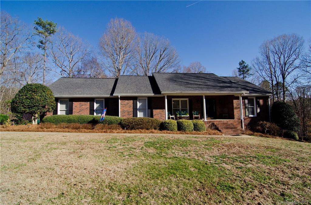All brick open ranch w/great flow & rocking chair front porch.Large deck for entertaining. So MOVE IN ready! 1.5 acre wooded lot, 2 car AND 1 car garage and tons of storage space & workshop.  New carpet throughout,new rennai tankless hot water, fenced yard,new showers in both bathroom,septic recently cleaned /pumped, and so much more!  Even has a dog room w/doggie door to outside. All this and convenient to everything -close to 85 & 485. Home has been well cared for & maintained and it shows.
