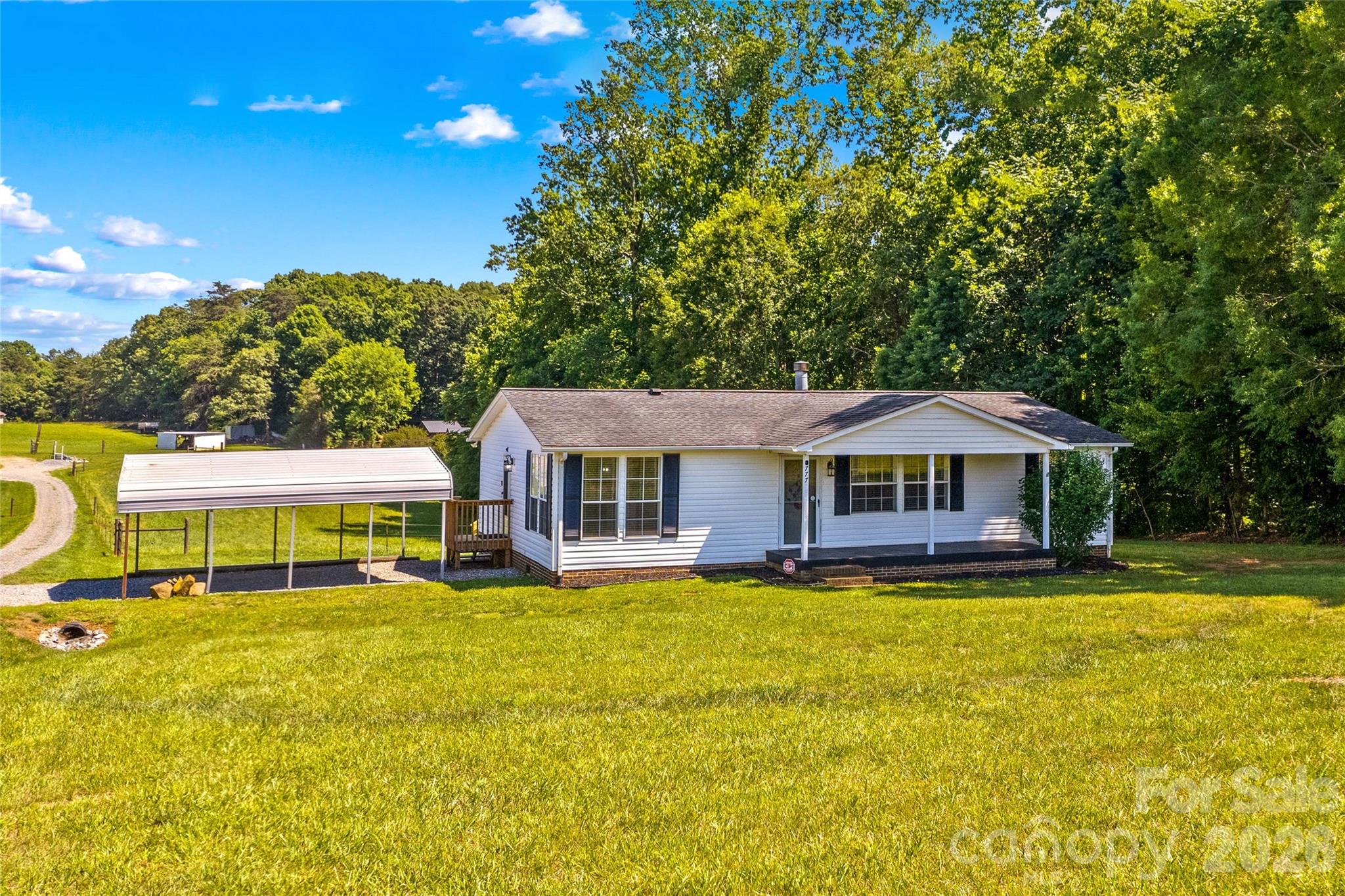 Country Living with No HOA!  Fully Renovated Ranch Home surrounded by Peaceful Acreage that your Buyers will love. Like New, inside and out, with brand New Deck, June 2026. Sit back and take in Nature's views from the Front Porch or Rear Deck. Inside, this Home has a Modern Farm House Look: New Paint, New Lighting, New LVP Flooring throughout, and New White Bathroom Vanities and Tub Shower combo.  The Vaulted Ceiling in the Great Room enhances the very light and open feeling. There's also a Fireplace with gas logs in the Great Room. A split Floor Plan Design; with the Primary Bedroom overlooking the Back yard.  The Large Primary Bath offers a Glass and Tile step in Shower, Brand new Double Vanities and Sinks, and a Walk in Closet. The Open Kitchen and Dining area are spacious, and include new Stainless Appliances. The Laundry Room includes a Pantry for Storage. New HVAC 2023, New Water Heater 2024, Roof 2016, New Vapor Barrier 2026. Driveway is on this property, and with this Sale, Sellers are installing their Driveway on Midway Road. Sellers to survey this home and lot from surrounding acreage, and provide new Survey. Close by I-40 access, Shopping, Dining, and Downtown Statesville is within 15 minutes. Convenient to Claremont and Hickory, too!