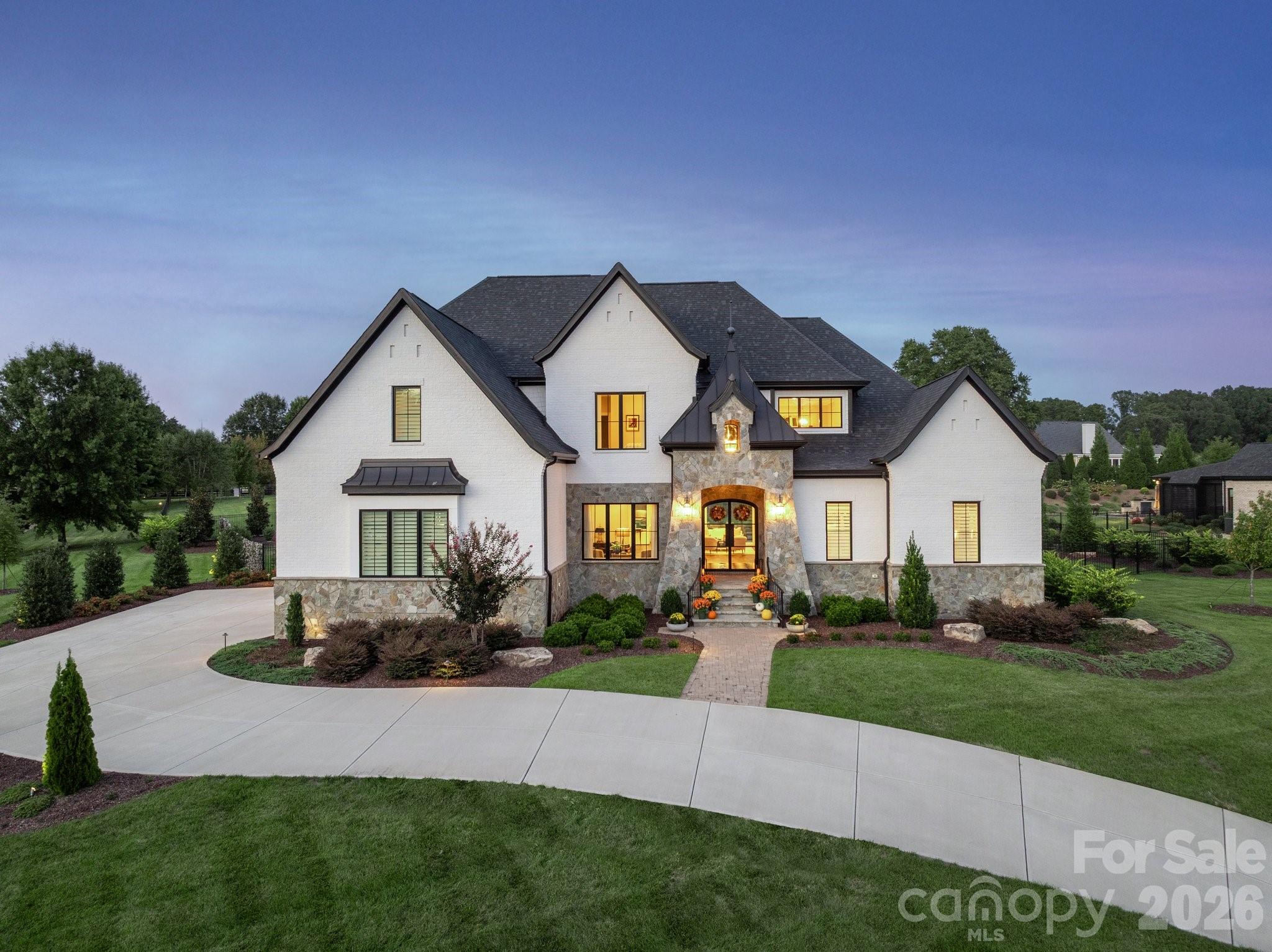 A Rare Offering in The Meadows at Weddington!

Discover refined craftsmanship and timeless style in this custom-built residence, perfectly positioned on a private, nearly one-acre corner lot within the gated community of The Meadows at Weddington. Designed with an uncompromising attention to detail, this home blends elegant architecture with luxurious modern comforts in every space.

From the moment you enter the grand marble-tiled foyer, every detail reveals a commitment to craftsmanship and comfort. The gourmet kitchen is a culinary masterpiece featuring an ILVE Italian 48” gas range, Top of the line Signature Kitchen Suite appliances and a hidden secondary pantry for seamless entertaining. A temperature-controlled 300-bottle wine wall with custom bar and ice maker creates a stunning focal point for gatherings.

The primary owner’s suite offers a serene retreat complete with a fireplace, custom closet with center island, LG Styler steam cabinet, and a spa-inspired bath with heated floors, a Hydro Systems tub, and an oversized zero-entry shower.

Sophisticated living continues throughout the home with designer lighting fixtures by Schonbek and other premium brands that illuminate each space with elegance. The insulated, epoxy-finished garage includes custom cabinetry, high ceilings suitable for a lift, and 220V pre-wiring for an electric car charger.

The second floor features a versatile club and media room complete with a wet bar, beverage refrigerator perfect for entertaining or relaxing in style.

Outdoors, indulge in resort-style living with a saltwater heated pool, sunken spa, and sun shelf, surrounded by lush, professionally designed landscaping. The expansive covered living area—complete with fireplace and built-in 36” grill—creates the perfect retreat for dining and entertaining.

This is more than a home—it’s a statement of sophistication, comfort, and craftsmanship, designed for those who expect nothing less than exceptional.