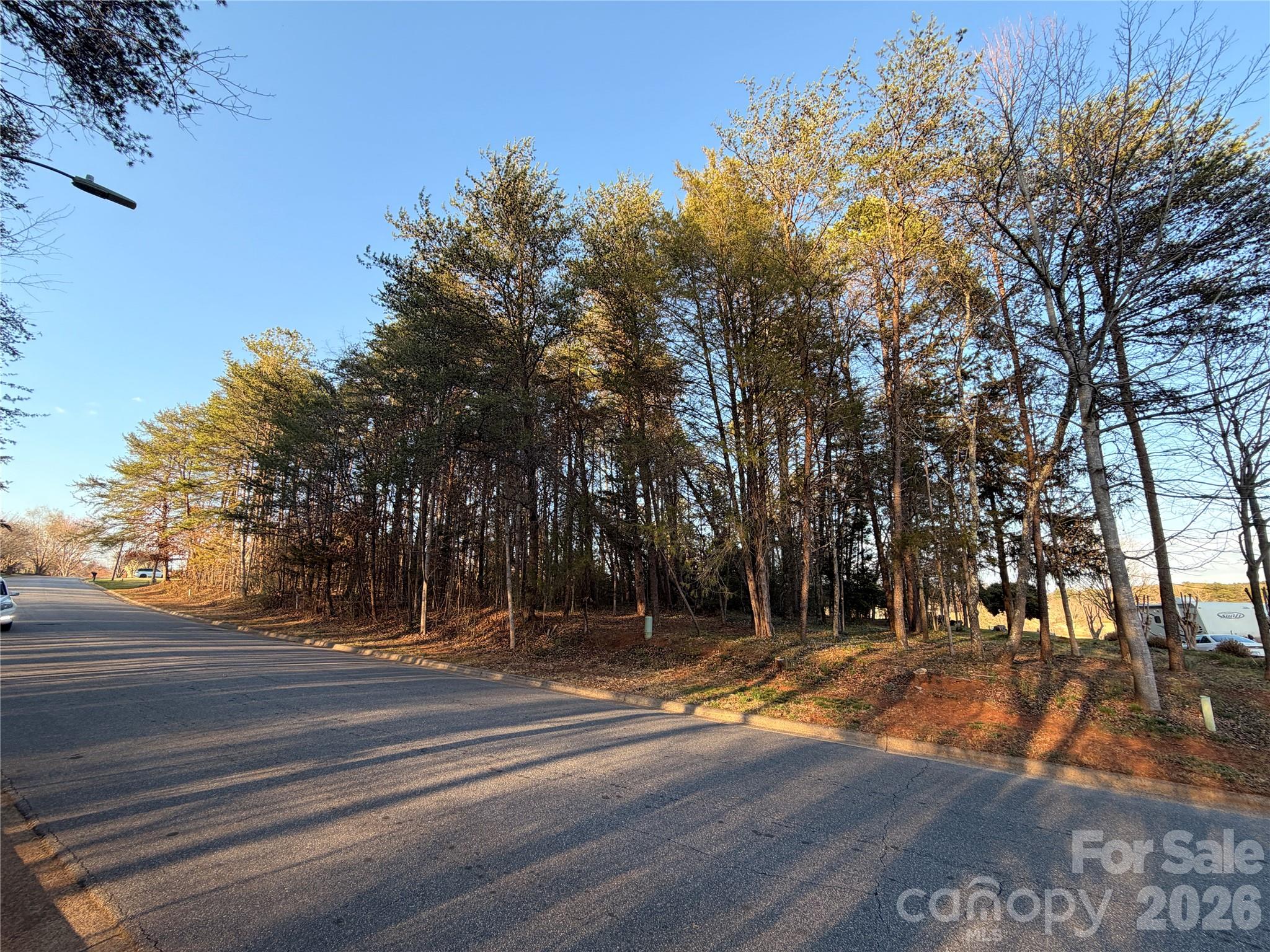 Back on the market at no fault of the seller, this .58 golf course facing lot sits directly along the fairway at Lake Hickory Country Club’s Catawba Springs course, offering daily front-row views of one of Hickory’s premier private golf facilities. It's next door lot (3779) can be combined for a larger 1.2 acre estate lot if desired.  Tucked into the established Catawba Springs Golf Community in northeast Hickory, the lot combines a peaceful residential feel with the convenience of being inside the city limits and just minutes from shopping, dining, and major roads.

Wake up to manicured fairways, mature trees, and the quiet rhythm of play unfolding just beyond your backyard as golfers finish out the hole in full view. Instead of driving to find green space, you can enjoy your morning coffee on a future patio or screened porch while watching approach shots, putts, and sunsets over the course. Evening walks follow tree-lined streets where many homes are positioned to take advantage of golf views, creating a neighborhood atmosphere that feels relaxed, social, and connected to the outdoors.

Life here is centered around Lake Hickory Country Club, which operates two facilities and describes itself as the premier private country club in Hickory with a “best in class” experience across golf, tennis, fitness, dining, and social amenities. At the Catawba Springs campus, members enjoy 27 holes of private golf, a full practice facility, and a clubhouse that serves as a social hub for dining, drinks, and events. Food and beverage service includes bar, grill, and restaurant offerings, and the club also provides meeting and banquet facilities for gatherings, celebrations, and special occasions.

Beyond the course, active living is supported by additional club amenities such as tennis, fitness, and organized programs for members. The club’s fitness center features aerobic machines, free weights, an indoor racquetball court with viewing area, men’s and ladies’ locker rooms, and steam or sauna facilities, along with classes like spin, yoga, and conditioning to make wellness a natural part of your weekly routine. Tennis and pickleball options, along with social events and junior activities, round out a lifestyle where it is easy to stay engaged without leaving the community.

Catawba Springs is governed by recorded bylaws and covenants administered by the property owners association, which are designed to preserve the neighborhood’s appearance and protect long-term property values. Owners planning to build or add improvements must also follow the City of Hickory’s land development and building regulations, with the more restrictive of the city or community rules applying, helping to maintain a cohesive streetscape and a well-kept environment around the golf course. Nearby golf community listings highlight city water, sewer, trash, and street lights, along with wired connectivity options, underscoring the blend of resort-style setting and practical everyday infrastructure in this part of Catawba Springs.

With its direct fairway frontage, private-club setting, and access to a full slate of country club amenities, this lot offers an ideal opportunity to design a custom home that feels like a year-round getaway—whether you are hosting friends after a casual round, watching the last group finish as the sun goes down, or simply enjoying the quiet beauty of living right on the golf course.