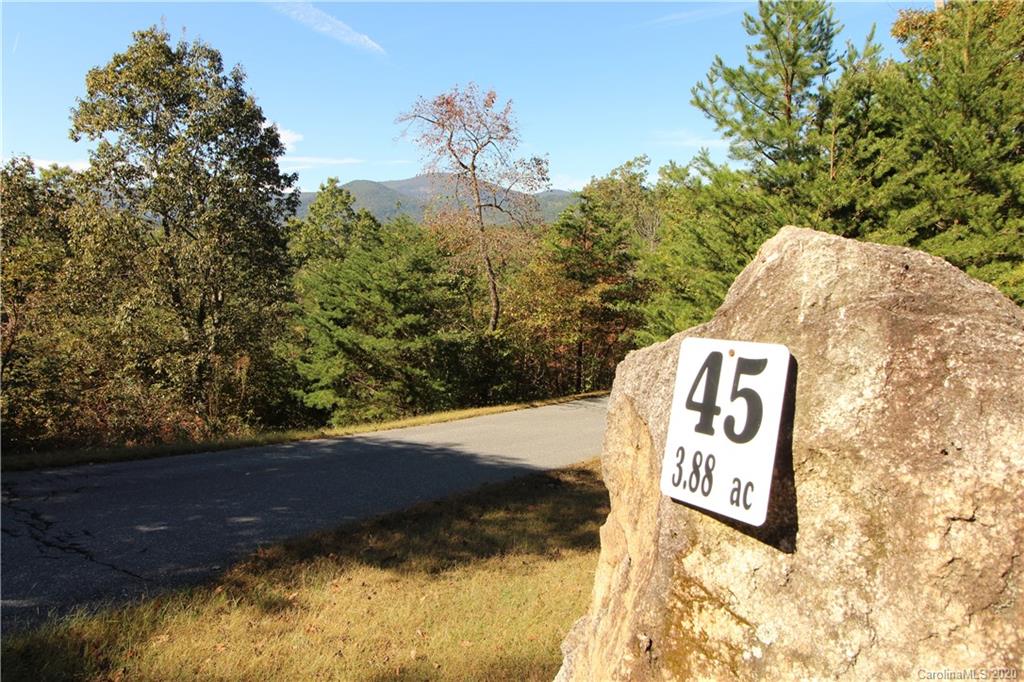 Recently widowed & motivated seller! Priced now 40K below original asking price! A beautiful property with many possibilities! Located high above in The Peaks at Lake Lure community. This 3.88-acre parcel has stunning 180-degree mountain views. The property is divided by a private shared road with cleared sections on both sides, a great option for your home and an additional garage for a workshop and extra storage. The Peaks is a gated community with paved roads and underground utilities. Located close to restaurants, grocery store, medical facilities, and just a short drive to Chimney Rock State Park and the Tryon International Equestrian Center (TIEC). Come build your dream home in one of Lake Lure's most desirable neighborhoods!