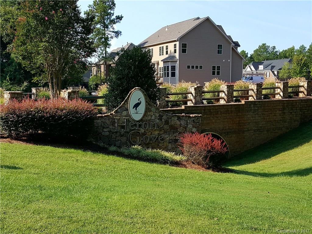 Location, Location, Location!!! Gorgeous wooded corner home site in sought after prestigious Heron Cove, Located in the heart of Lake Wylie.  Build your distinctive custom home from a select list of pre-approved builders, this secluded community is only 20 minutes to uptown Charlotte, convenient to shopping, dining, CLT Douglas airport and is assigned to award-winning Clover Schools! Very few opportunities remain in this stunning community, don't miss out on your dream home!