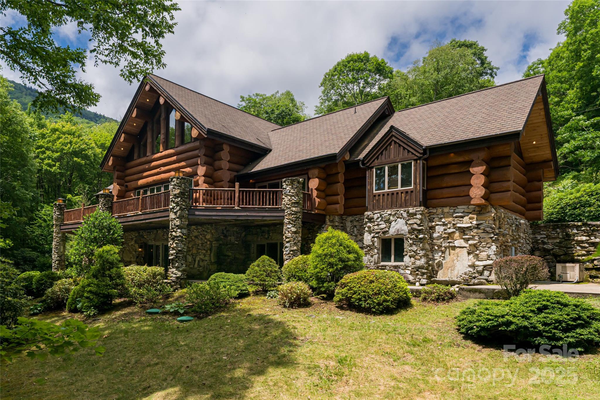 A residence of rare provenance & craftsmanship, this trophy Montana-style log home offers a once-in-a-generation chance to own a mountain estate steeped in history & lore. Built with logs sourced from the iconic Biltmore Estate, and set on a lush park-like 3.5+/- acres with trout pond, this home blends Appalachian heritage with architectural elegance. Prolific rockwork, ironwood decking, copper gutters, oversized 2-car garage, & a lodge-style porte-cochère reflect meticulous detail. Inside, soaring ceilings, massive stone fireplaces, & a dramatic grande entry create a bold & warm welcome. The main level features a luxurious primary suite, great room made for entertaining, & eat in kitchen; while below 2 bedroom suites, 2nd living room & bonus room await. Custom hickory cabinetry, cherry hardwoods, & artisan finishes complete the one-of-a-kind home. With both privacy & proximity, this home is a statement of mountain excellence—bringing Big Sky dreams to the heart of the Blue Ridge Mtns.