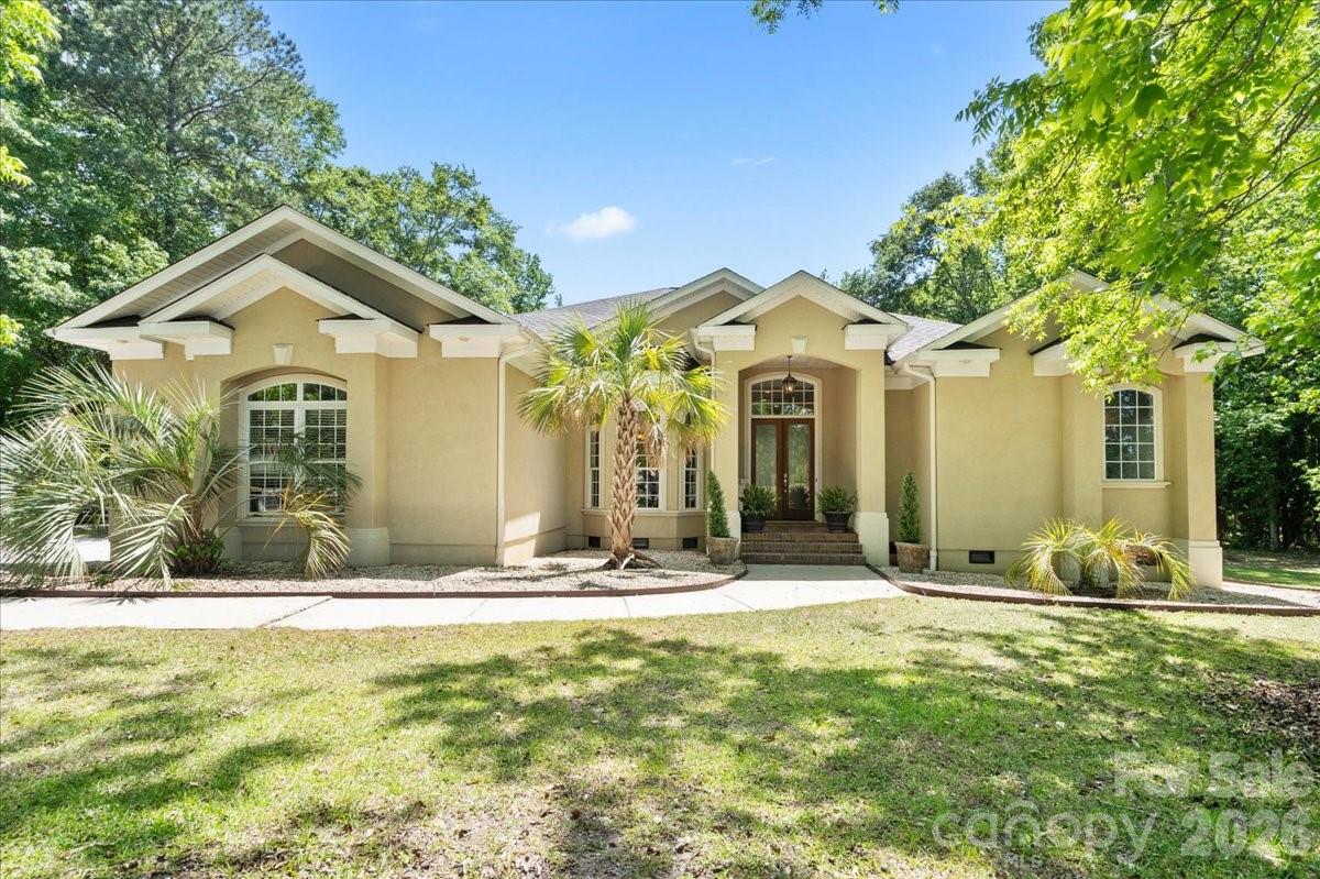Back on the market no fault of the sellers! 
Tucked away on a beautifully wooded 1.38-acre lot in the charming town of Chesterfield, this stunning one-story stucco home offers the perfect blend of space, function, and timeless appeal.
Step inside to a dramatic two-story grand entry that sets the tone for elegant yet comfortable living. The formal dining area flows seamlessly into a spacious great room—ideal for entertaining, a piano space, or a cozy conversation lounge.
Designed for flexibility, this home features an oversized primary suite with private access to the covered back porch, creating a peaceful retreat. Three additional bedrooms provide plenty of room for family, guests, or your evolving lifestyle—one is currently used as a home office, making it a perfect flex space for work, play, or hobbies.
Outdoors, the property truly shines. Enjoy warm Carolina days by the in-ground pool with an impressive 9.5-foot depth, all surrounded by the privacy of mature trees. In addition to the attached two-car garage, you’ll appreciate the detached garage/storage building with electricity—ideal for projects, storage, or extra vehicles.
Whether you’re hosting gatherings, working from home, or simply enjoying the tranquility of small-town living, this home is designed to meet your needs at every stage of life.
Agent is related to seller