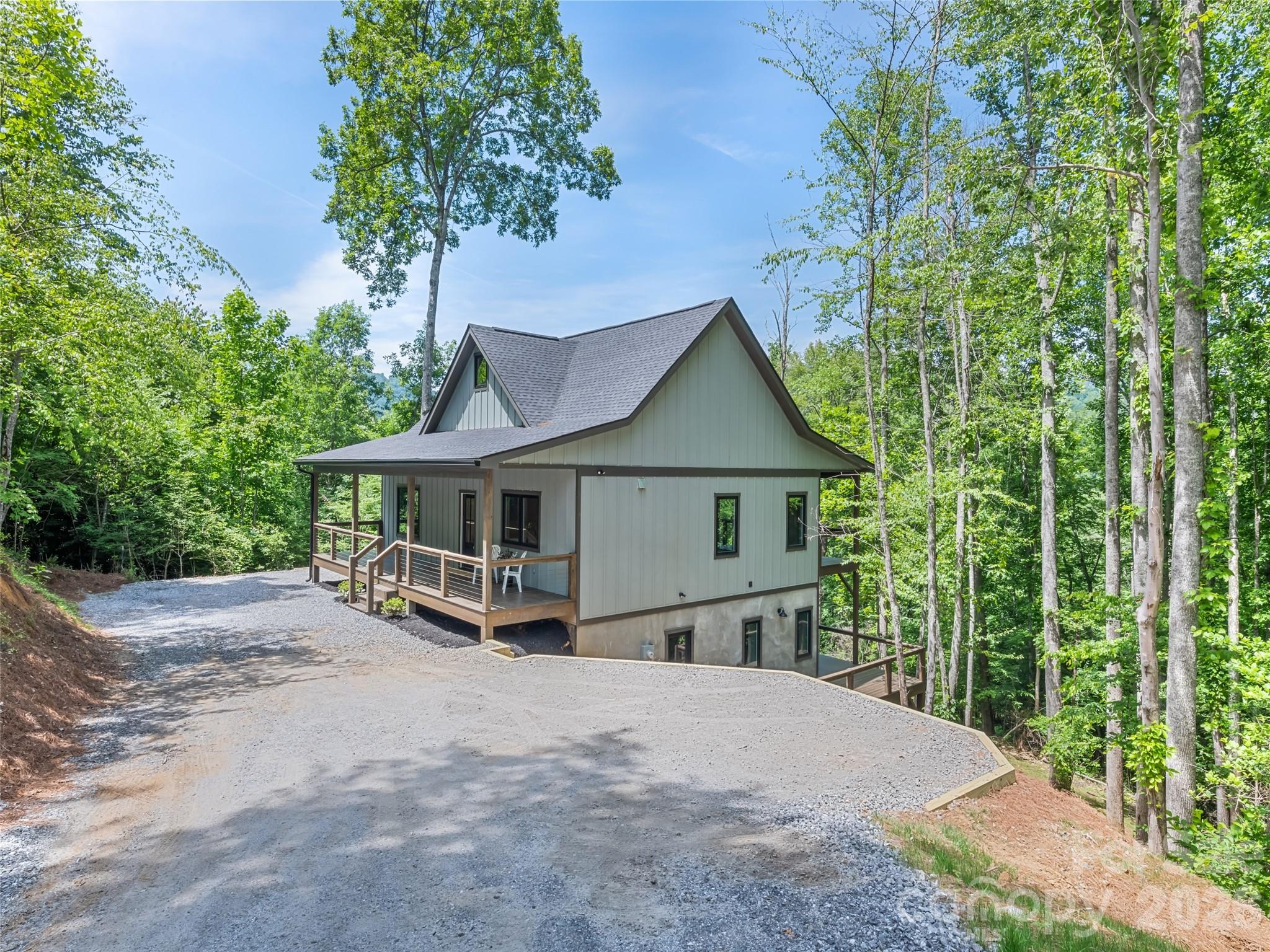 Location and privacy to please those seeking to call The Ridge at Irontree home! Well developed and pristine neighborhood entered by the scenic views of the Pigeon River, flowing creeks, and surrounded by majestic long range mountain views. This Modern Farmhouse just completed with elegance, skill & care offers an open spacious kitchen boasting of Whirlpool appliance, Quartz countertops, oversized kitchen window, pantry, large island with ample seating and Shaker cabinets. White Oak hardwood floors lead you through the main level open concept with vaulted Tongue & Groove ceiling in LR, Primary BR, 2nd BR/BA and laundry all have 9 foot ceilings. The daylight walkout basement provides Concrete finished floor Family room plus 3rd BR/BA, storage, utility or project room. Both levels reveal covered porches front & back to host family & friends. Be centered near all area attractions in the Great Smoky Mountains! NEW Improved driveway access! Responsive seller provides 1 year builder warranty!