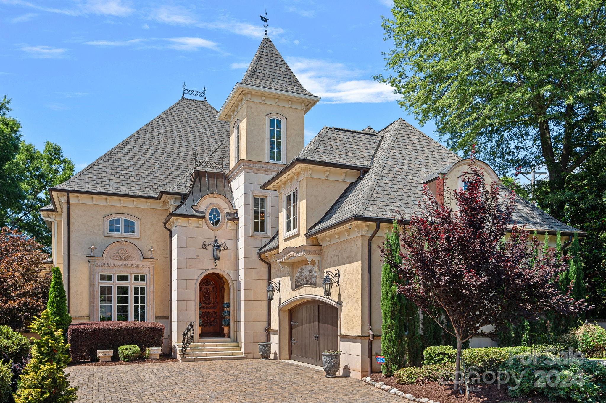 Peninsula Chateau brimming with old world charm and sweeping sunset views. Delight in modern and luxurious finishes throughout, then step out onto 300+ feet of Lake Norman shoreline. Elegant textures such as limestone, hard coat stucco, Moroccan fossil stone, and travertine, are paired with the warmth of custom inlayed cherrywood floors, copperwork, mosaics, murals, and a generous gourmet kitchen with custom cabinetry. Experience lake view serenity from your lavish main-level primary suite, or climb the spiral cast iron staircase to your own wood-vaulted observatory tower complete with glass dome cupola. Unique features include a 2-story Italian colonnade, 2 garages to house 4 cars, modular floor, covered veranda, columned balcony, lakeside rec room, and an elegant wood-paneled office. HOA covers boat slip, dock maintenence, lawn care, community pool, and tennis courts. Neighborhood lends the perfect blend of privacy as well as convenience to nearby amenities. NEW ROOF (6/2024)
