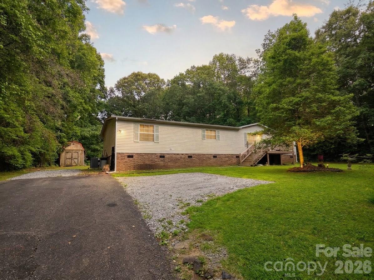 Welcome to peaceful country living in Bessemer City with space, privacy, and endless possibilities. This unique opportunity includes both 1276 Forest Ridge Road and 1270 Forest Ridge Road, combining for approximately 1.38 acres of usable land surrounded by a quiet setting and natural beauty.

Offering 3 bedrooms, 2 bathrooms, and 1,728 square feet, this home features a comfortable layout with a stunning see-through fireplace connecting the living room and family room, creating warmth and character throughout the heart of the home. Large living spaces provide flexibility for entertaining, movie nights, gatherings, or simply relaxing at home.

The kitchen appliances, washer, and dryer all remain, making this property move-in ready from day one. Important updates have already been completed, including a roof, HVAC system, and well pump that are all approximately 6 years old. The home also includes a RainSoft Carolina water filter/purifier system for added convenience and peace of mind.

Outside is where this property truly shines ? Two additional buildings offer incredible space for storage, hobbies, workshop areas, recreational equipment, or future creative uses. With two separate lots included, there’s room to expand, garden, create outdoor entertaining areas, park recreational vehicles, or simply enjoy the privacy and freedom that comes with owning extra land.

If you’ve been searching for a property with acreage, versatility, and country charm while still being convenient to nearby amenities, this one delivers the kind of potential that’s hard to find.