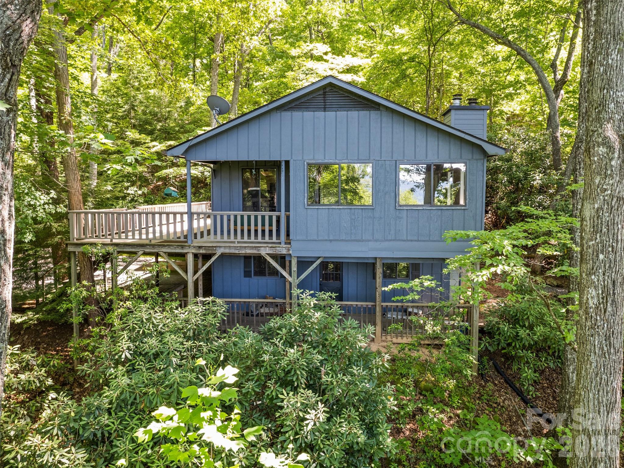 You must see this true mountain paradise that is hidden in the trees at 3500 feet elevation. This house has pocket views in the summer and wide-spanned views in the winter with amazing fall colors. With paved access and fiber-optic internet, you will have the comforts of city life in a rural setting. Two bedrooms and two bathrooms are located on the main floor while a third bathroom is located in the basement . The finished basement has both an interior and an exterior entrance.  This allows for extra comfort for hosting guests and additional living space. This desirable location is just minutes from downtown Waynesville, Canton, Lake Logan, and Pisgah hiking/biking trails.  You will enjoy the privacy and the cool mountain summers in this peaceful mountain retreat!