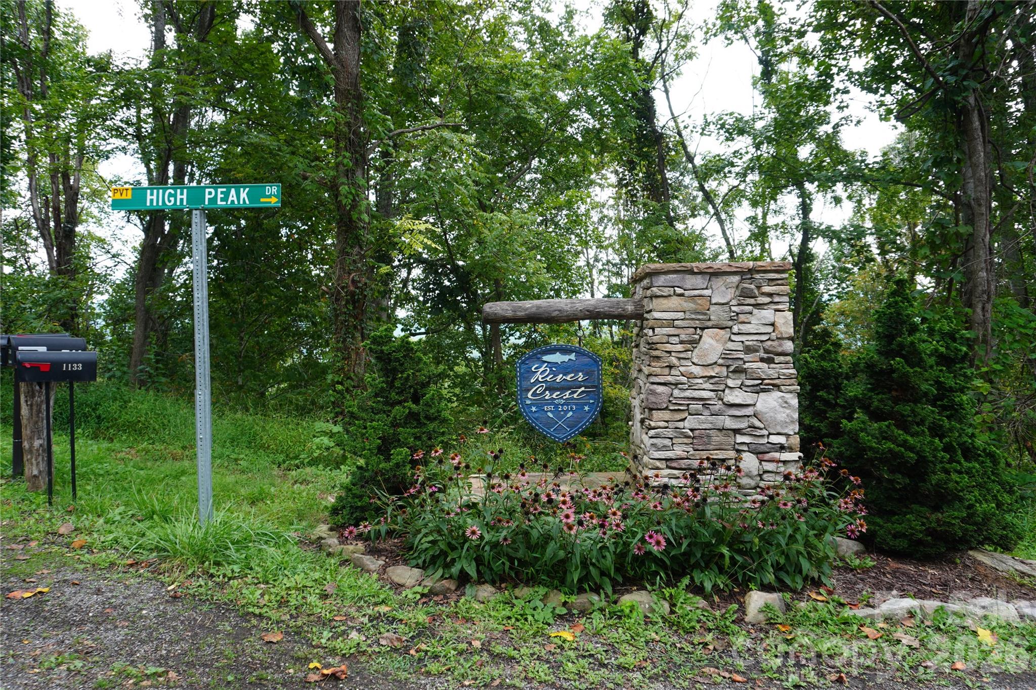 Imagine waking up to crisp mountain air and the quiet hush of the Blue Ridge all around you. This 1.95-acre homesite in River Crest offers more than land—it offers a lifestyle. Tucked inside a private, gated community, it’s a place where you can build the mountain home you’ve always imagined. Just moments from the sparkling Toe River, spend your days fishing in cool waters, floating peacefully downstream, or gathering with friends for a picnic by the shore.

At River Crest, the community “Greenspace” common area invites you to slow down and savor mountain living—with Toe Riverfront access for fishing, a hiking trail, fire pit, and grill all waiting for you to sit back, relax, and enjoy the beauty around you. Residents also enjoy thoughtful amenities including a gated entry, underground electricity, fiber optic internet, and private river access—combining the charm of the mountains with the conveniences you need.

Here, nature and modern convenience come together, providing the perfect canvas for a full-time residence or a weekend retreat where every visit feels like renewal. Beyond the gates of River Crest, Burnsville awaits—just 40 minutes from Asheville and about 90 minutes from the Great Smoky Mountains National Park’s Cataloochee Valley. This charming mountain town offers a rare combination of majestic peaks, star-filled night skies, and vibrant local culture, from farm-to-table dining to welcoming shops. Burnsville is the ideal place to immerse yourself in the beauty, adventure, and lifestyle of the Blue Ridge Mountains.
OWNER Financing Available