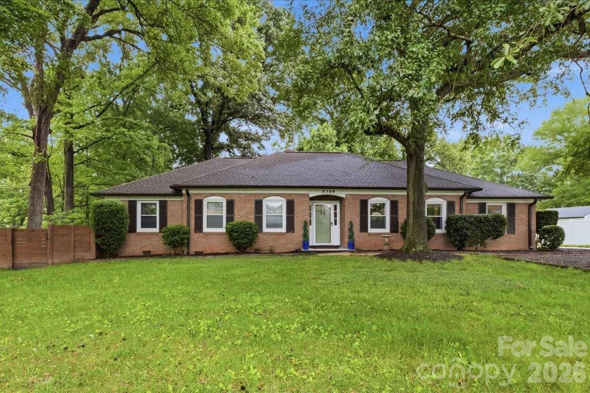 This beautifully maintained and thoughtfully updated 3 bedroom/2 bath brick ranch (offered with no HOA!) rests on over half an acre, delivering a rare combination of space, comfort and enduring appeal. Inside, rich hardwood floors extend throughout a light-filled family room, creating a warm and inviting introduction that flows seamlessly into a dedicated dining area accented by classic wainscoting.

The well-appointed kitchen offers abundant cabinetry and generous counter space, ideal for both everyday living and effortless entertaining. Just beyond, a spacious living room is anchored by a striking fireplace and opens to a screened-in porch, offering you the ideal space to unwind while overlooking the expansive backyard, now enhanced by a newly installed six-foot privacy fence.

The primary suite serves as a true retreat, featuring a fully renovated en-suite bath with designer finishes, including a sleek barn door, penny tile flooring, quartz countertops and an oversized tiled walk-in shower. Secondary bedrooms are generously sized and share an updated full bath complete with a new vanity and quartz surfaces.
Significant recent improvements include a brand-new septic system (2026), HVAC (2024), hot water heater (2025), built-in surround sound, and a 50-year roof (2024), along with updated outdoor lighting and refreshed front landscaping, providing peace of mind for years to come.

Ideally located, the home sits just moments from Westminster Park, a 320-acre natural preserve along the Catawba River offering miles of trails, sports fields, a playground, ropes course, camping and canoe access. In the opposite direction, convenient access to a private school and nearby shopping center places dining, retail and daily essentials within easy reach.

With its generous indoor and outdoor living spaces, thoughtful updates and prime location, this home offers a refined yet relaxed lifestyle designed for modern living!