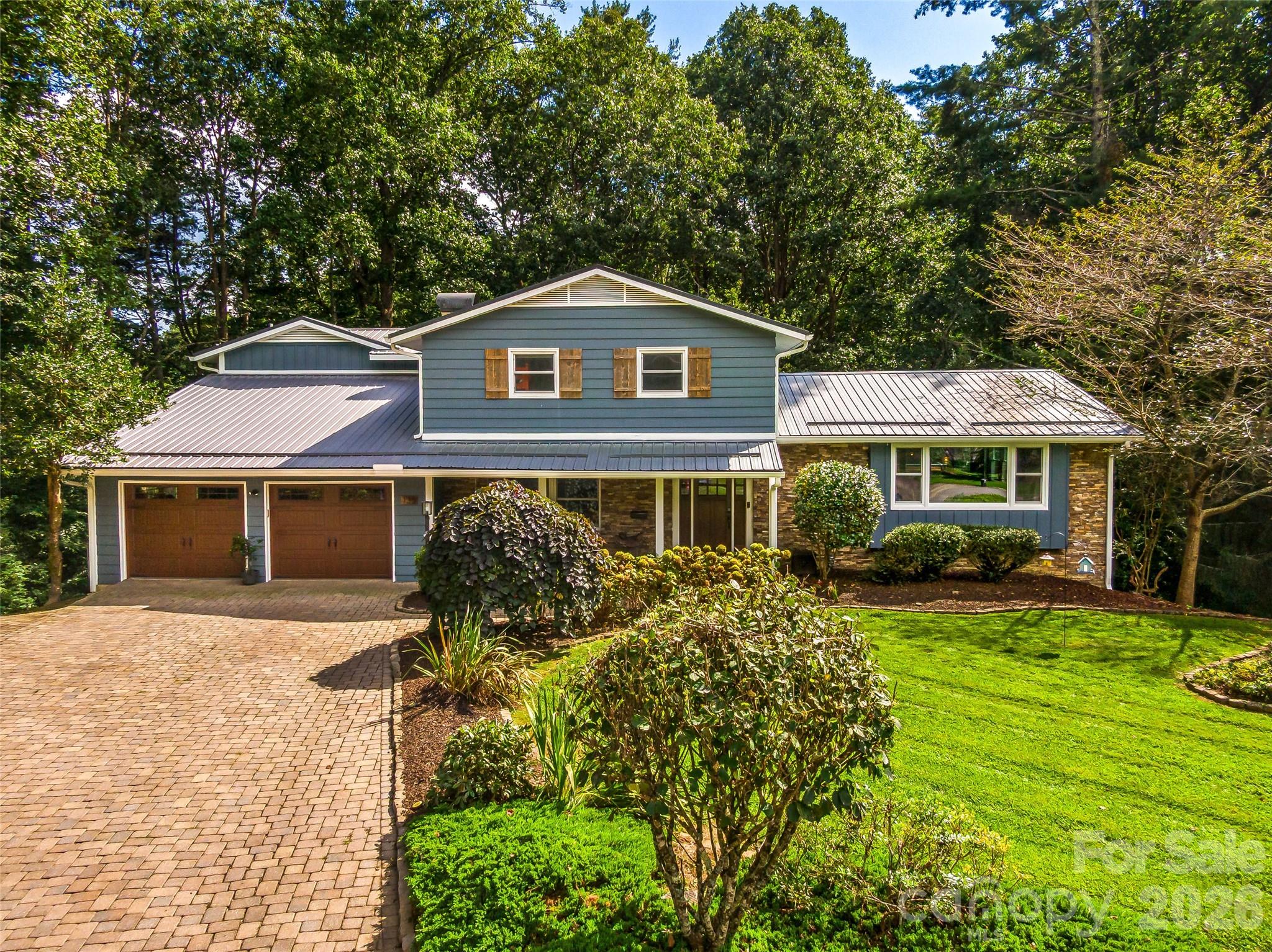 Welcome to 135 Dogwood Drive, an updated home in one of Brevard’s most convenient and sought-after locations—just a short, easy walk to downtown Brevard and only steps from Silvermont Park. This property combines modern renovations, flexible living spaces, and outdoor features that set it apart from anything else on the market.
Inside, the home shines with a completely redesigned and renovated kitchen and main-level living space. Custom cabinetry, upgraded appliances, sleek countertops, a large island, and a butler’s pantry create the perfect gathering hub. The open floor plan flows naturally, framed by large windows for abundant light. A True undercounter beverage center adds convenience right in the kitchen. The large primary suite is a private retreat with its own screened-in porch and a bathroom featuring heated tile floors, a garden bathtub, and a walk-in shower. In total, the home provides five-plus bedrooms with multiple bonus areas, giving you flexibility for guest rooms, home offices, creative studios, media, fitness, or hobby use. On the lower level, the home transforms into an entertainer’s dream. The custom-crafted bar is a showcase of craftsmanship and design, featuring shelves built from reclaimed floor joists salvaged from an old Brevard home, cabinetry faced with reclaimed barnwood from Tennessee, and a bar top and countertops of quarter-sawn white oak. Premium appliances include a Scotsman pellet ice machine and a second True brand undercounter beverage center, ensuring the perfect setup for gatherings. Outdoor living is equally impressive. A rear deck resurfaced with new Trex composite decking provides low-maintenance space for grilling, dining, or soaking up the mountain air. The spacious fenced-in backyard offers privacy, room to play, astroturf for year-round greenery, and even a small stream along the edge of the property. It’s a rare find so close to downtown. Practical features include a large two-car garage, generous storage throughout, and a level brick paver driveway for easy year-round access. 135 Dogwood Drive blends modern updates, custom details, and a prime in-town location. Schedule your showing today!