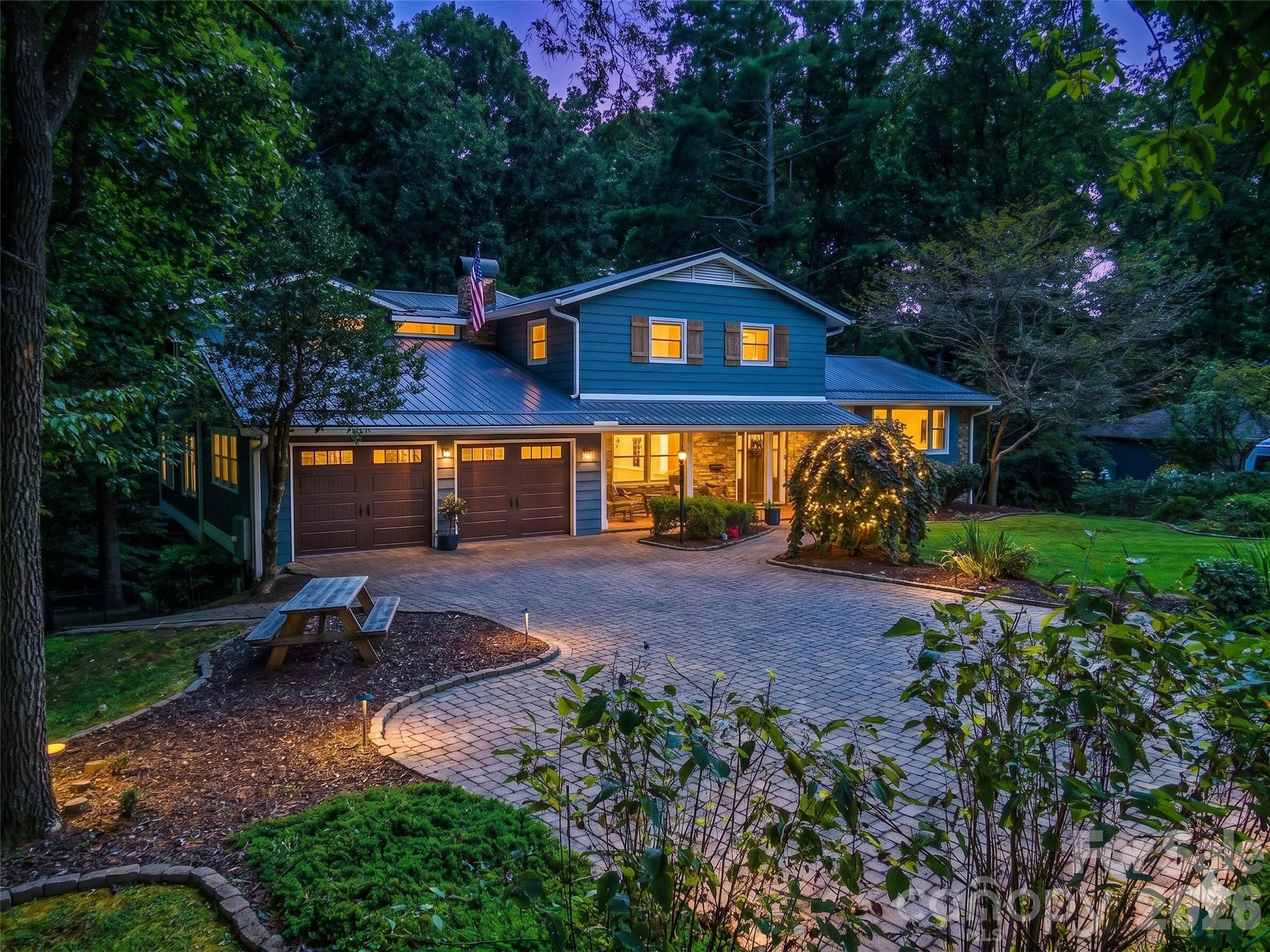 Welcome to 135 Dogwood Drive, an updated home in one of Brevard’s most convenient and sought-after locations—just a short, easy walk to downtown Brevard and only steps from Silvermont Park. This property combines modern renovations, flexible living spaces, and outdoor features that set it apart from anything else on the market.
Inside, the home shines with a completely redesigned and renovated kitchen and main-level living space. Custom cabinetry, upgraded appliances, sleek countertops, a large island, and a butler’s pantry create the perfect gathering hub. The open floor plan flows naturally, framed by large windows for abundant light. A True undercounter beverage center adds convenience right in the kitchen. The large primary suite is a private retreat with its own screened-in porch and a bathroom featuring heated tile floors, a garden bathtub, and a walk-in shower. In total, the home provides five-plus bedrooms with multiple bonus areas, giving you flexibility for guest rooms, home offices, creative studios, media, fitness, or hobby use. On the lower level, the home transforms into an entertainer’s dream. The custom-crafted bar is a showcase of craftsmanship and design, featuring shelves built from reclaimed floor joists salvaged from an old Brevard home, cabinetry faced with reclaimed barnwood from Tennessee, and a bar top and countertops of quarter-sawn white oak. Premium appliances include a Scotsman pellet ice machine and a second True brand undercounter beverage center, ensuring the perfect setup for gatherings. Outdoor living is equally impressive. A rear deck resurfaced with new Trex composite decking provides low-maintenance space for grilling, dining, or soaking up the mountain air. The spacious fenced-in backyard offers privacy, room to play, astroturf for year-round greenery, and even a small stream along the edge of the property. It’s a rare find so close to downtown. Practical features include a large two-car garage, generous storage throughout, and a level brick paver driveway for easy year-round access. 135 Dogwood Drive blends modern updates, custom details, and a prime in-town location. Schedule your showing today!