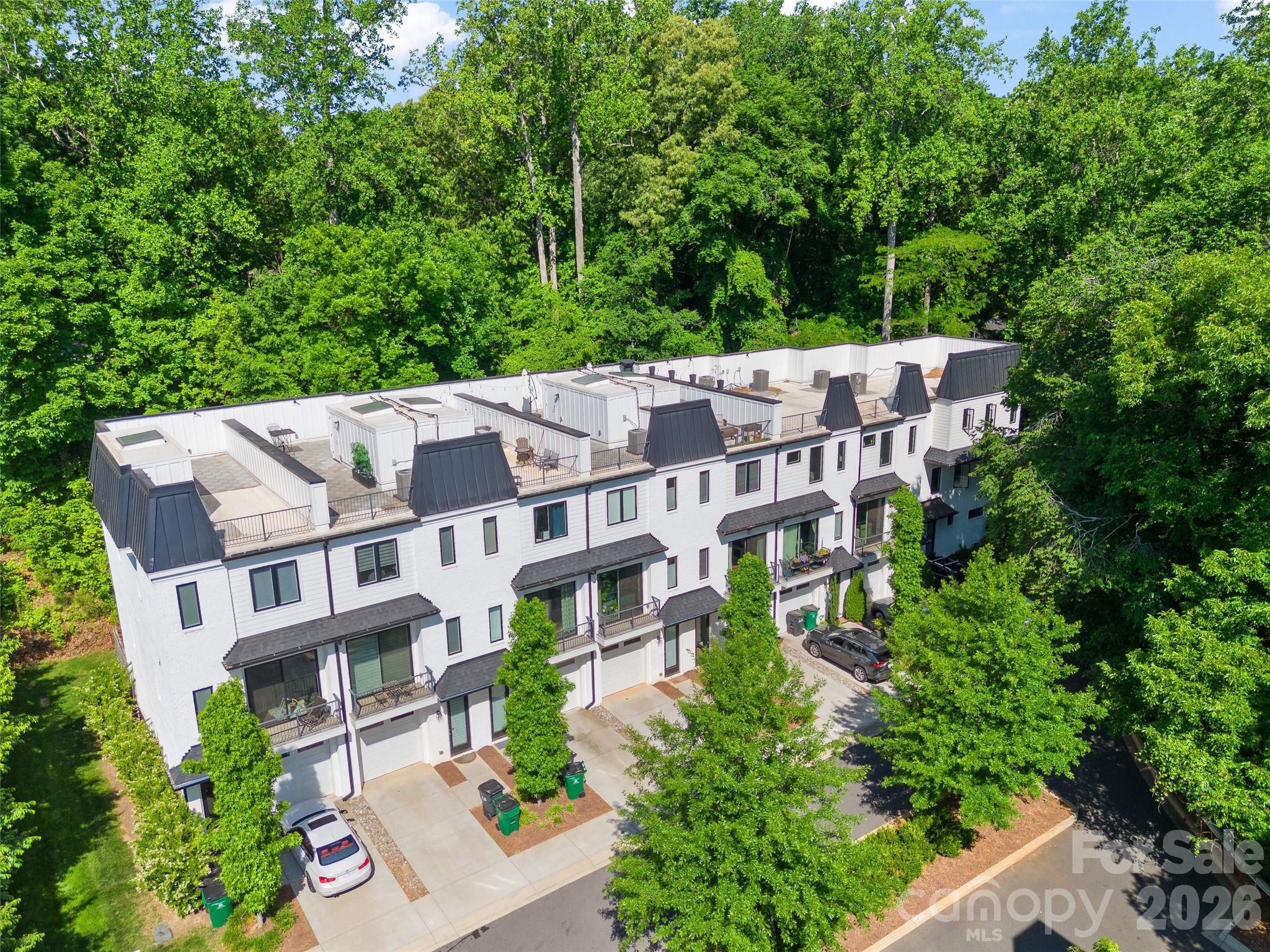 Lender Incentive Available. Inquire Today!  Beautiful townhome built in 2020, offering elevated living with direct access to the Greenway. This three-bedroom, three-and-a-half-bath home features abundant outdoor living space and a versatile floor plan. Rooftop Terrace offering the best of indoor- outdoor living in the city. Lush trees provide a beautiful setting. With no units directly outside of any windows, this townhome offers great privacy. 

The main level includes a private bedroom and full bath with access to a rear patio, complete with turf and backing to green space. The open-concept living area showcases a spacious kitchen with a large island, breakfast bar, dining area, and an expansive living room with a gas fireplace. High ceilings allow natural light to flow throughout the home.
Upstairs, a split-bedroom layout provides privacy, featuring the primary suite and an additional guest suite, along with a conveniently located laundry area. A skylight fills the stairwell with natural light and leads to the rooftop terrace, which overlooks the Greenway and surrounding green space. Rooftop is perfect for enjoying the greenery in this urban location, a true gem. 

Ideally located, this home offers peaceful outdoor living in an urban setting, just minutes from SouthPark, South End, and more. Situated in a small enclave of townhomes, it provides both privacy and the ease of newer construction living without the oversized neighborhoods and high HOAs. Overflow parking for gatherings offered at the adjacent church.