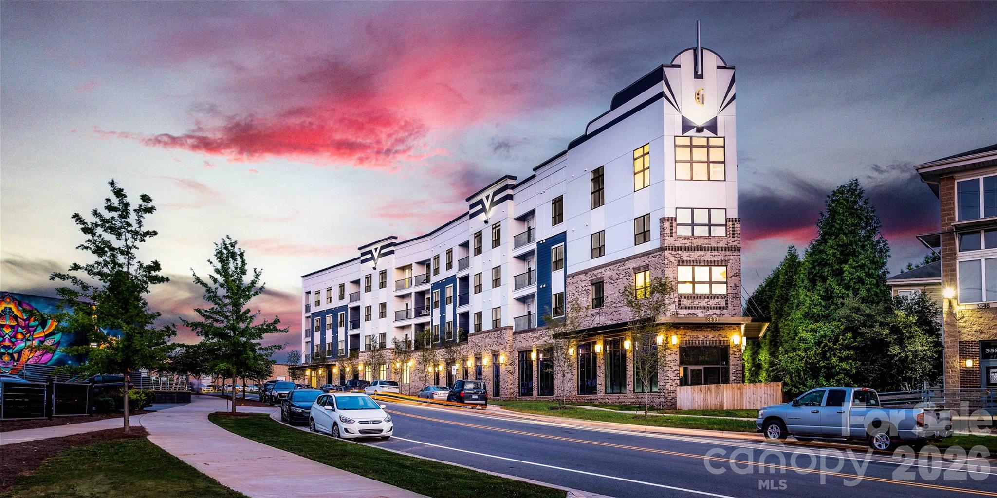 New Construction Premium corner unit at Galleries of NoDa.  180 degrees of windows provides a breathtaking view of N Davidson & the Light Rail Line.  The home has a very contemporary floor plan for an owner with a designer touch.  Community has a large amenity deck with fire pits and grills.  Condo comes with two deeded parking spaces and a deeded storage locker.