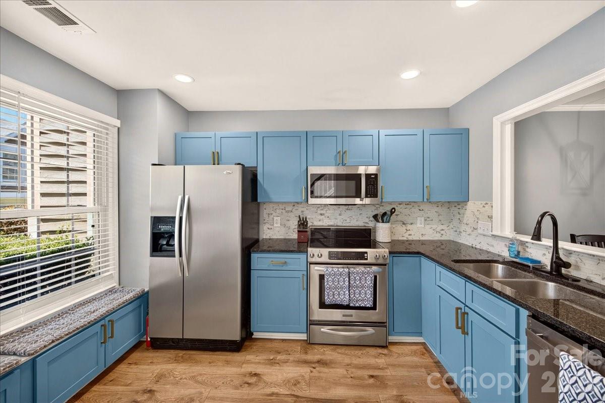 Welcome to 8220 Legare Ct, an updated townhome-style condo with a private fenced patio in The Gates at Quail Hollow! A 2-story foyer with skylight creates a warm welcome, and brand new LVP flooring throughout the main level adds a fresh, modern feel. The kitchen features granite countertops, blue cabinetry with subtle character, bench seating with extra storage, and stainless steel appliances, including a newer microwave, dishwasher, and garbage disposal. The open concept living area has refreshed paint and is anchored by a wood-burning fireplace with a newer mantel and white brick surround, and framed by built-ins and shelving. Just off the living room, the private fenced paver patio is the perfect spot to relax or entertain. A conveniently located powder room with a brand new toilet completes the main level. Upstairs, both bedrooms feature vaulted ceilings and ensuite baths, and the primary bedroom has a walk-in closet. Notable upgrades include LVP or tile throughout (no carpet!), smooth ceilings (no popcorn!), newer blinds, Nest thermostat, crown molding & wainscoting, plus updated lighting & ceiling fans. The newer roof (2023) and HVAC (2021) provide peace of mind. The Gates at Quail Hollow is a tranquil neighborhood with a pool & hot tub, clubhouse, fitness center, and tennis courts, while offering close access to the Greenway, SouthPark, grocery, restaurants, coffee, and more. Welcome home!