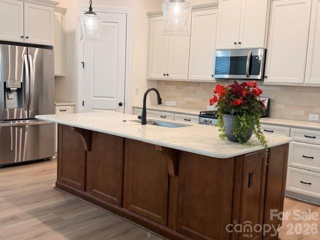 Just reduced and move-in ready! A rare opportunity in Encore at Streamside 55 and up community. —  Beautifully upgraded, ideally located, and thoughtfully designed for easy main-level living with additional space upstairs.
Perfectly positioned on a premium interior corner lot across from a wooded area, this home offers added privacy, a quieter setting away from main roads, and a larger backyard footprint. Inside, the open and light-filled floor plan is enhanced with designer finishes and comfortable, elegant living spaces. The gourmet kitchen is the centerpiece of the home, featuring a large quartz island, oil-rubbed bronze hardware, upgraded lighting, abundant cabinetry, and generous gathering space ideal for entertaining or everyday living. The inviting living area with fireplace flows seamlessly to the all-season covered porch—perfect for morning coffee, evening relaxation, or entertaining friends and family. The main-level primary suite provides a peaceful retreat with a spa-inspired shower and thoughtful details designed for comfort and convenience. A guest bedroom and dedicated office/flex room with French doors are also located on the first floor.  Upstairs, the spacious bonus room with full bath and closet offers exceptional flexibility as a guest suite, hobby room, media room, or additional office space, along with convenient walk-in attic storage.

Exterior maintenance and lawn care are included, allowing you more time to enjoy the incredible amenities Encore at Streamside is known for. Community features include a stunning 6,000 sq ft clubhouse, fitness center, pickleball courts, walk-in pool with sun shelf and in-water lounge seating, outdoor fireplace, dog park with covered seating, walking trails, and an active social calendar coordinated by an on-site Lifestyle Director.
Voted the #1 New Home Community in Charlotte, Encore at Streamside offers resort-style living just minutes from historic downtown Waxhaw, shopping, restaurants, local events, and the Southwest Regional Library. Lots of activities coordinated by an on site Activity Director.  There is even a dog park!
This home offers the rare combination of premium lot placement, thoughtful upgrades, low-maintenance living, and vibrant community lifestyle. Don’t miss your opportunity to make it yours — call today to schedule your private tour.
