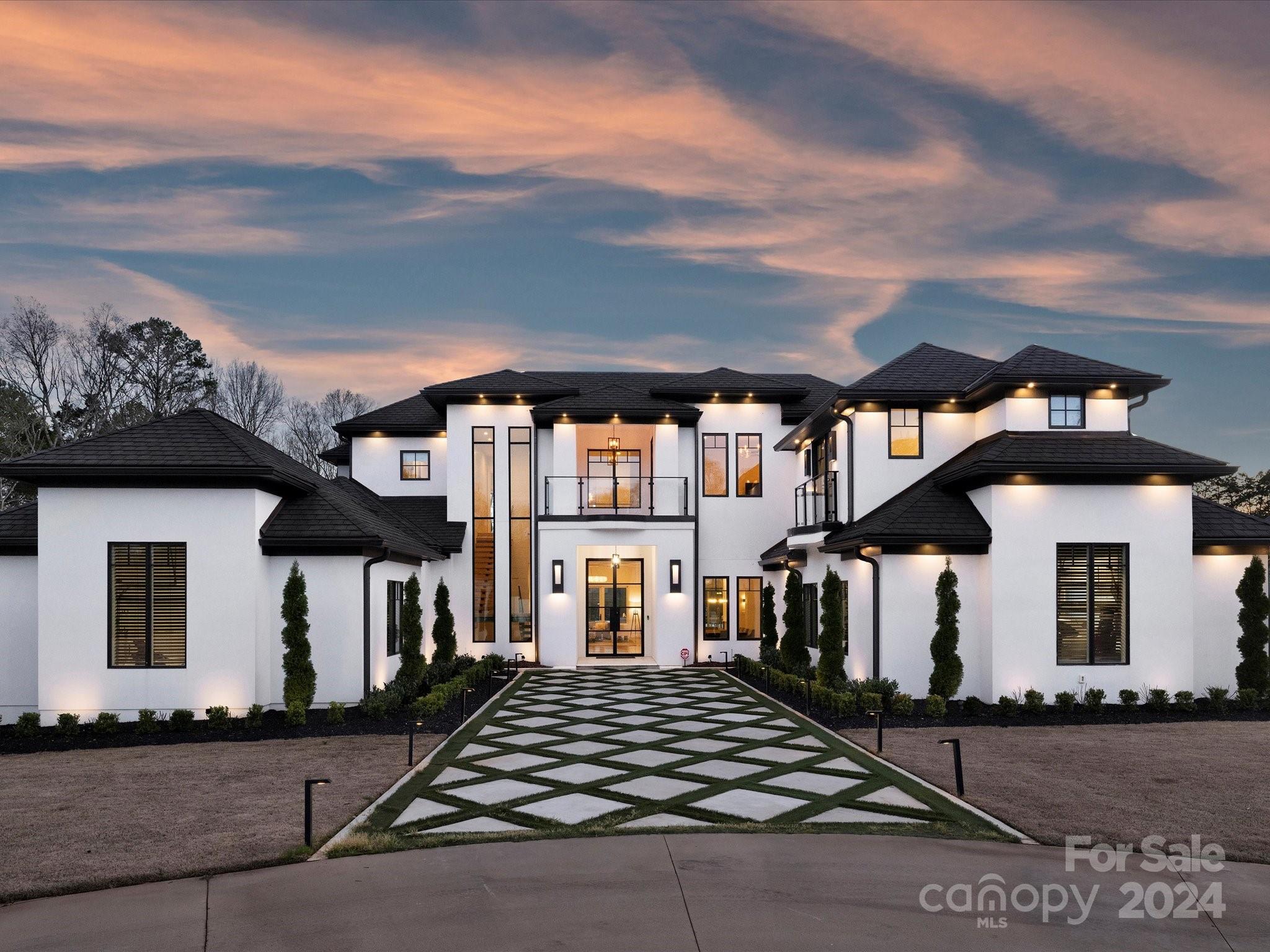 Fabulous modern home built in 2020 sits on a 1.7acre fenced & gated estate. This sleek home has everything! Soaring ceilings, floating staircase, open floor plan, large windows, glass enclosed wine/bourbon room, huge kitchen with 2 lg waterfall islands, tons of storage, Viking appliances, Hans Krug cabinetry. Family room & living room have gas fireplaces. Retractable doors open to a fabulous backyard! Large covered full outdoor kitchen, gas grill, 4 beverage refrigerators, covered patio, full bath, beautiful saltwater infinity edge pool with fountains, custom hot tub, 2 fire bowls, 16 person gas firepit, speakers, & plenty of yard for soccer & football! Primary suite is on the main with 2 walk-in closets, sitting area, fireplace & access to patio. The ensuite has a walk thru shower & soaking tub. Office, drop zone, lg laundry room. Upstairs: 5 bedrooms & 5 baths, bonus room, laundry room, lg balcony access from 3 bedrooms. Closets for elevator. TifTuf Bermuda grass. 5 min. to SouthPark