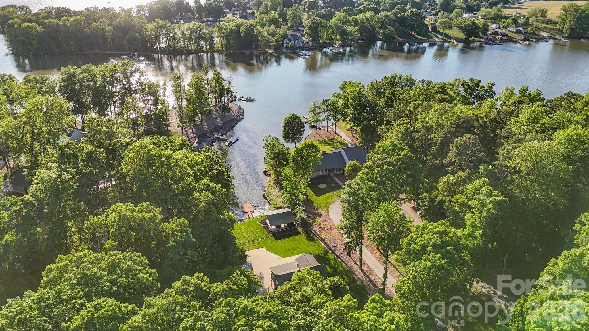 Charming 3BR/2.5BA lakefront home on High Rock Lake offering comfort, space, and the ideal lake lifestyle. This inviting property features a well-designed layout with a partially finished basement—perfect for a recreation room, home office, or guest space. Enjoy the beautifully designed outdoor pavilion, ideal for entertaining or relaxing while taking in the peaceful surroundings. Whether you're looking for a full-time residence or weekend retreat, this home is a great opportunity to enjoy lake living. Convenient boat access to local restaurants, ice cream, and fuel stops with no bridge restrictions. Pier permit with Cube Hydro: $100 annual renewal fee and $175 one-time transfer fee paid by buyer at closing. Preapproved buyers welcome! 2026 tax value shown; 2025 tax rate listed, 2026 rate TBD.