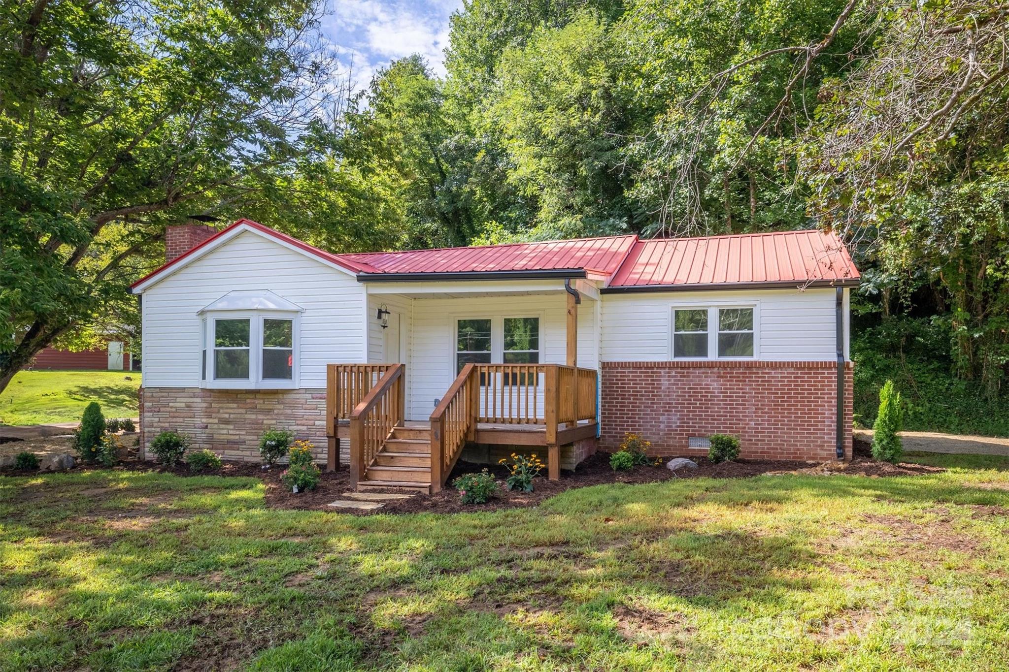 Adorable remodeled 3 bed/2 bath home with 6 ACRES! Located close to Lake James and Downtown Marion, this home offers an open concept floor plan and easy 1-level living. Recent remodel includes windows, HVAC, water heater, plumbing, electrical, sheetrock, paint, well pump, septic system, light/plumbing fixtures, carport roof, and more. Stylish design and colors throughout with new LVP flooring. You will love the kitchen boasting brand-new cabinets, granite counters, SS appliances, and island. Both full baths have also received a full remodel. Outside, enjoy the detached carport with workshop (has power), new covered front deck, and pasture with partial fencing. Mostly level land and NO CITY TAXES!