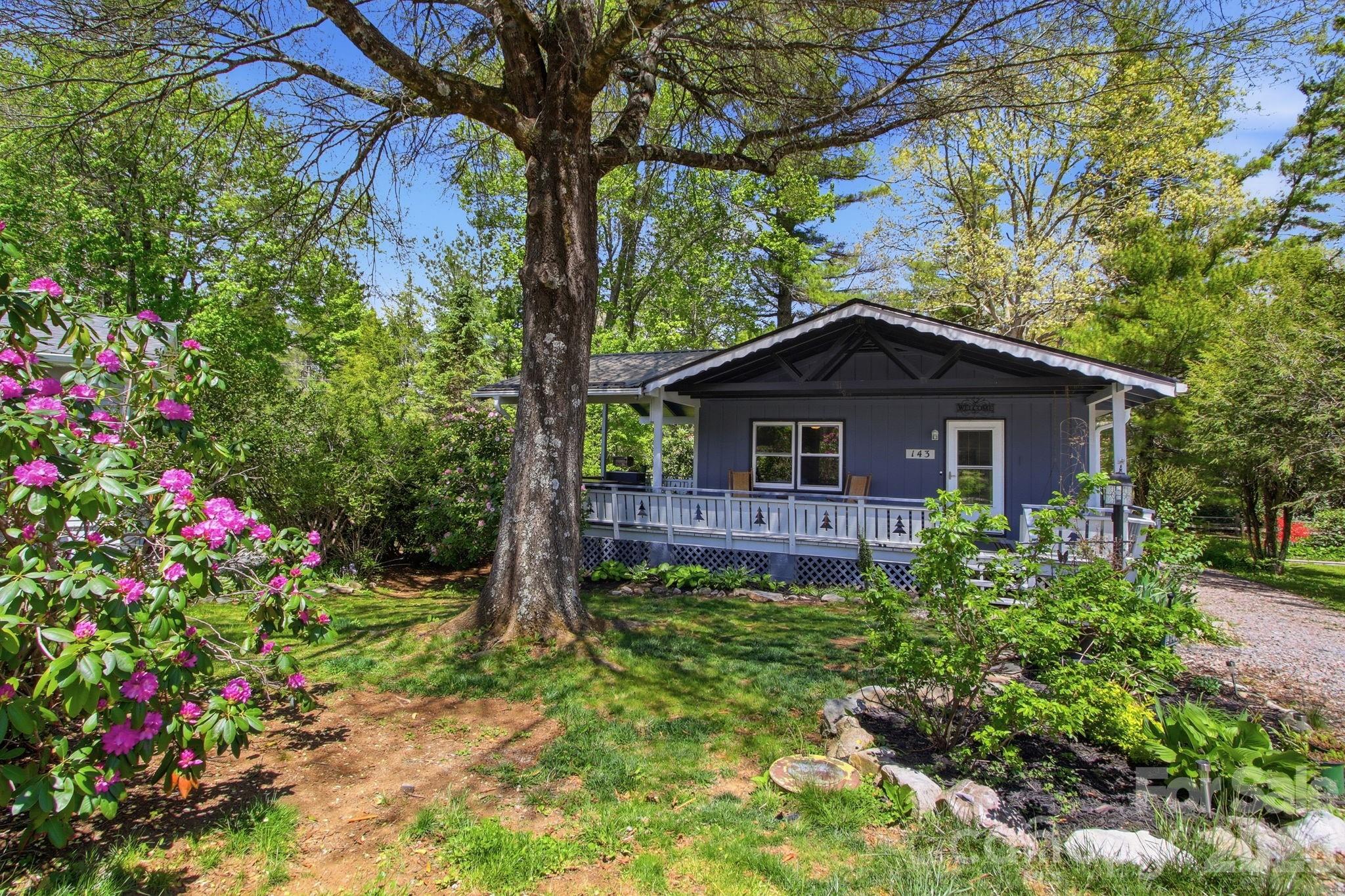 Simplify your life in this charming mountain cottage in the desirable Linville Land Harbor Community. It features 2 bedrooms, 2 bathrooms, and a below-grade flex room currently used as a sleeping area. Another game, craft, or family room is on the lower level. The property includes a wrap-around covered deck for relaxing and enjoying the serene surroundings. The pass-through driveway provides street access from both the front and back of the home. There is space for your golf cart in the golf cart garage. Recent upgrades include a new metal roof, gutters, tilt-in windows, a new shower tub combo, and a new hot water heater. Additional features include full RV hookups and ample space to pull your RV in. Community amenities include seasonal recreation activities, a game room, two dog parks, pickleball and tennis courts, a pool, a recreation center, trout fishing, a lakeside beach, kayak racks, and a golf course. Association dues cover water, sewer, cable, internet, 24-hour security, clubhouse access, a stocked river and lake, hiking trails, and trash pick-up. Explore nearby attractions such as Linville Caverns, Linville Gorge, Linville Falls, Pisgah National Forest, and Grandfather Mountain, as well as skiing, river rafting, shopping, and dining. This cottage offers a perfect blend of comfort, convenience, and outdoor adventure!