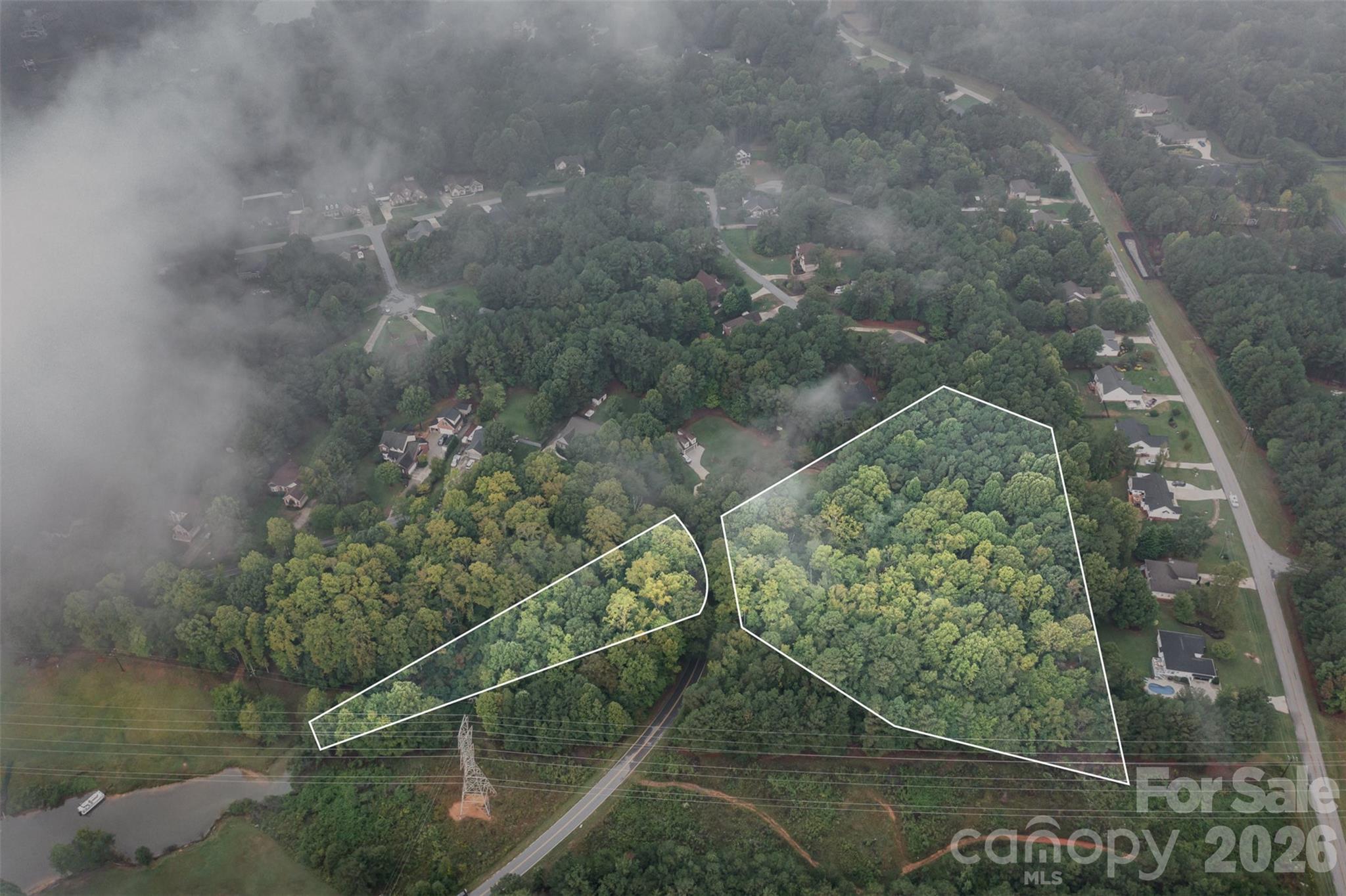 Build your dream house on this beautiful 4.3 acre combined lots that boasts lots of trees for privacy along with part of the lot that crosses the road with access to Lake Norman.  Bring your kayak or paddleboard to paddle along the lake or launch your boat from the private boat launch area that offers ample parking for you to enjoy a refreshing day on the lake. This community offers a private beach area with picnic tables, chairs, basketball nets and a gazebo.  Duke Energy has a powerline easement on the far right side of the property, diagram is attached. There is no boat dock permitted with this property per Duke Energy due to the shoreline classification, but don't worry, the community has a private boat launch area for all residents to use.