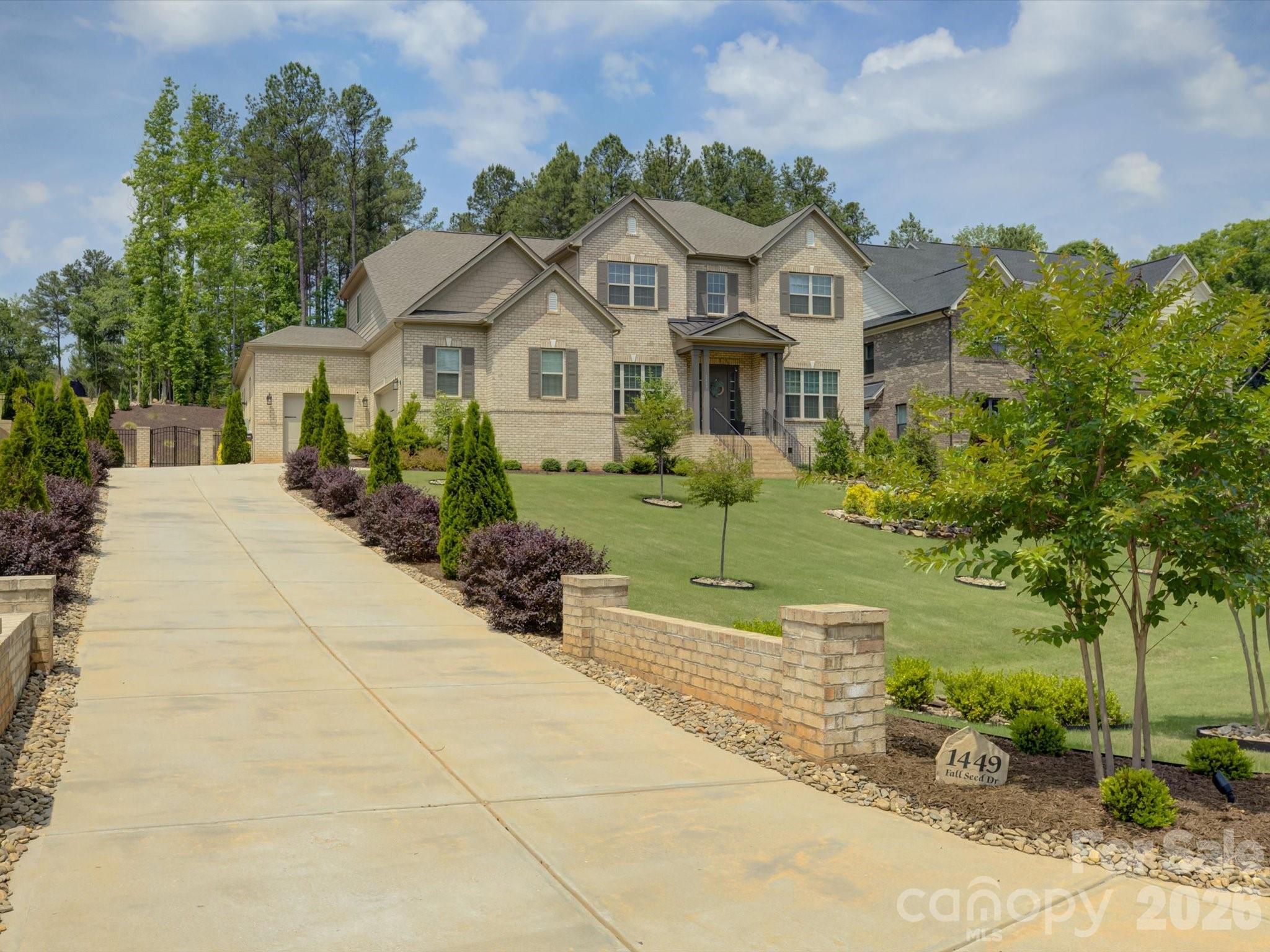 Set on a rare full acre in Fort Mill—well known for its highly desirable public schools—this meticulously maintained home stands out in the sought-after Trinity Ridge community. The sellers have invested extensively in the landscaping, creating a truly special setting with decorative stonework, fresh sod, curated plantings, and custom lighting. Inside, the home shows like a model. A private office with French doors is set across from a formal dining room, which leads into a soaring two-story great room that fills the home with natural light. The great room opens to a spacious kitchen with quartz counters, an oversized island, and a gas cooktop. The main level features both a vaulted primary suite and a private guest suite. Upstairs offers 3 additional guest rooms—one with an ensuite and another full bath—along with a fully soundproofed theater room. The rear screened porch with motorized screens creates a seamless indoor-outdoor retreat, and the epoxy-finished three-car garage with a car lift adds standout function.
