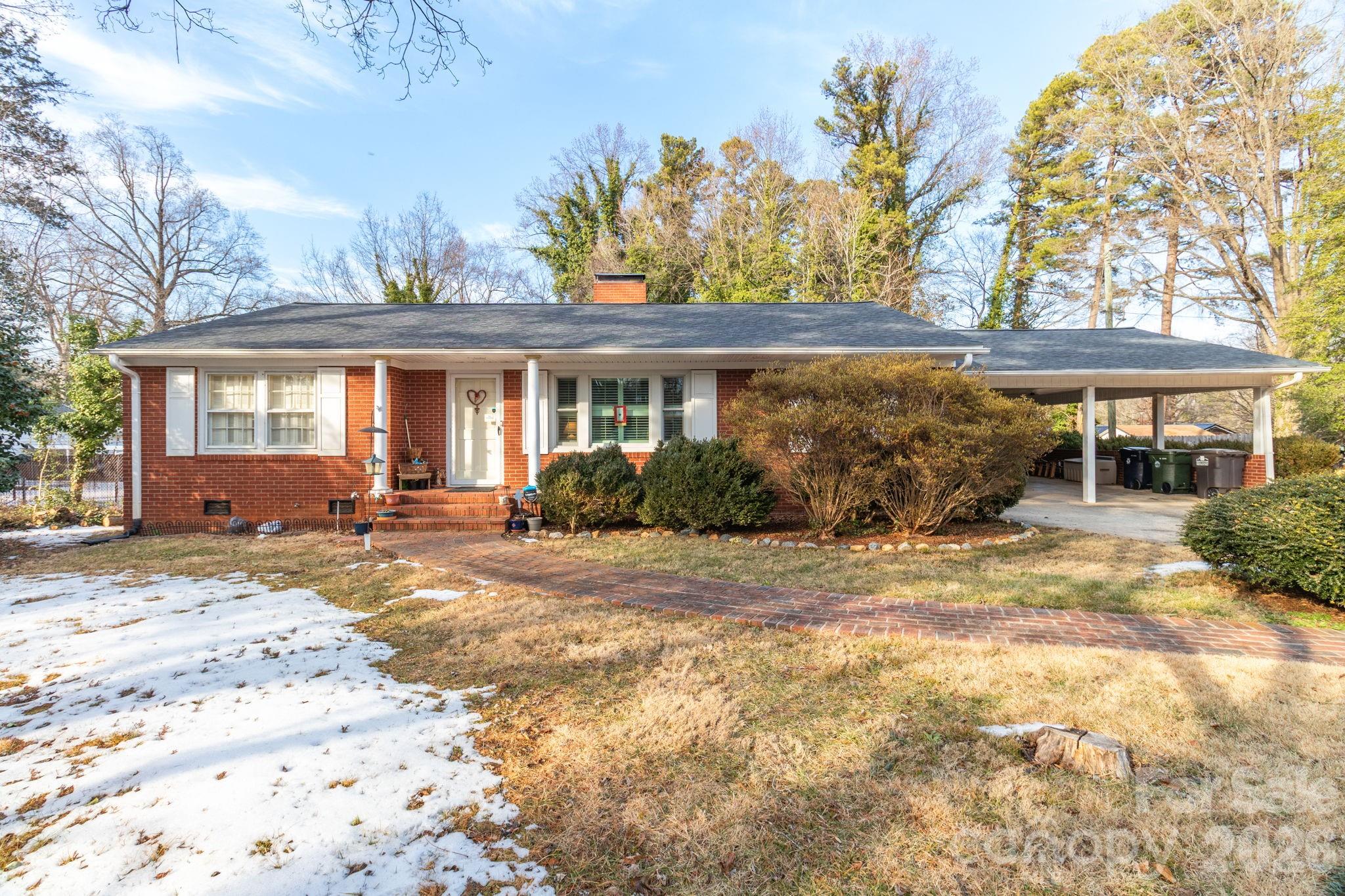 Welcome to 305 Hilltop Dr in Lexington—a classic brick ranch on a 0.34-acre lot. This 3-bedroom home offers a timeless layout with three family rooms and multiple living spaces for everyday comfort. The living room features a cozy fireplace, while the den includes its own fireplace and a stunning double-sided bookcase. A third living area adds flexibility. Enjoy two gas log fireplaces (one with a rustic railroad tie mantle) and one wood-burning fireplace. The kitchen is centrally located with a bright breakfast area, plus two dining areas for gatherings. The primary bedroom features his-and-hers closets plus an additional main closet. Interior window shutters add charm throughout. Relax in the sunroom with skylight and backyard views. Additional highlights include two large double-sided bookcases, a gas water heater, and HVAC gas pack system. Spacious yard completes this inviting home.