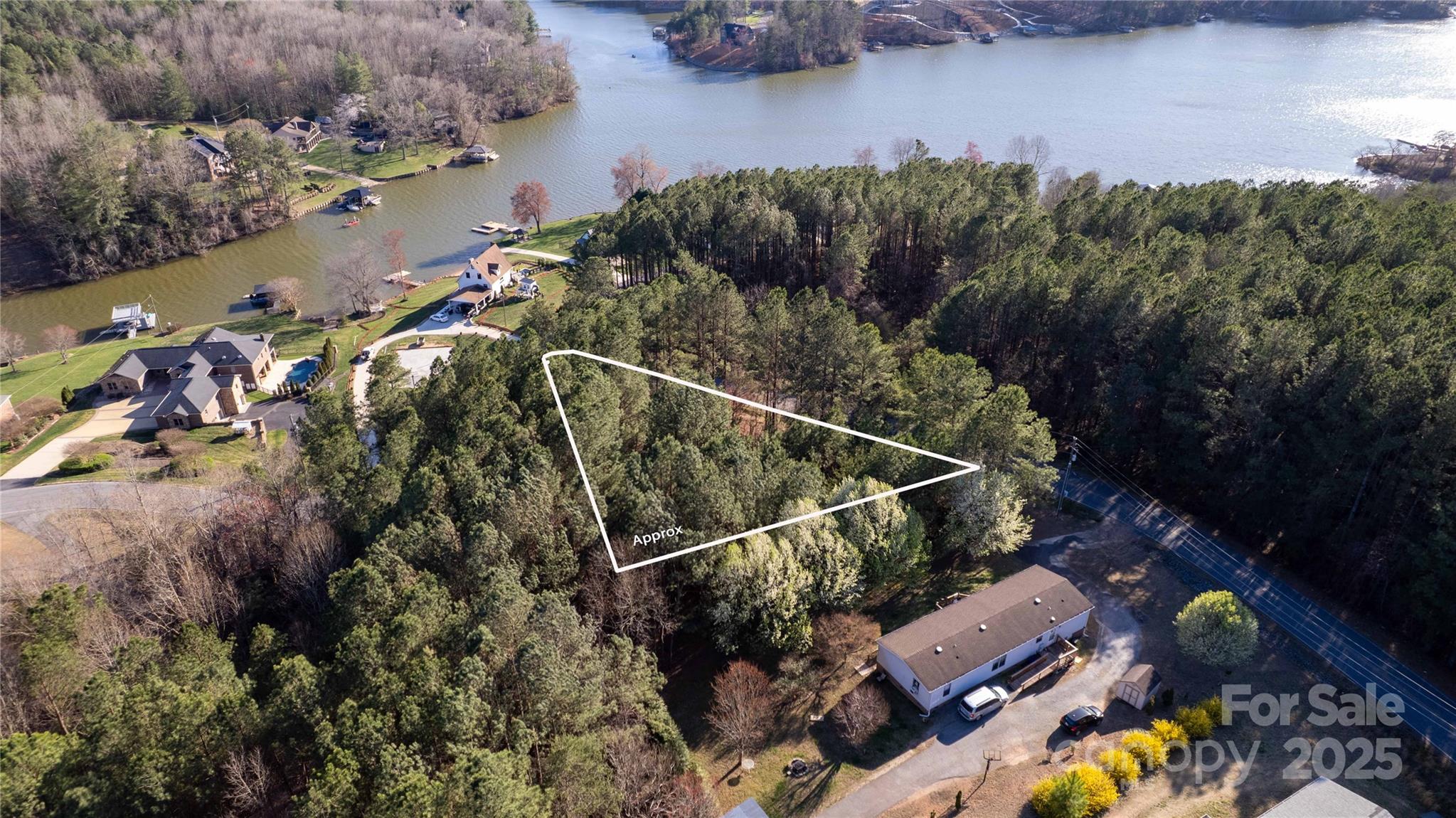 Stunning wooded lot with beautiful lake views! Nestled near the boat ramp, this prime location offers privacy, natural beauty, and easy water access. Perfect for building your dream home or a peaceful getaway. Septic Permit for 3BR from 2000. *NOT LOCATED IN A FLOOD PLAIN*