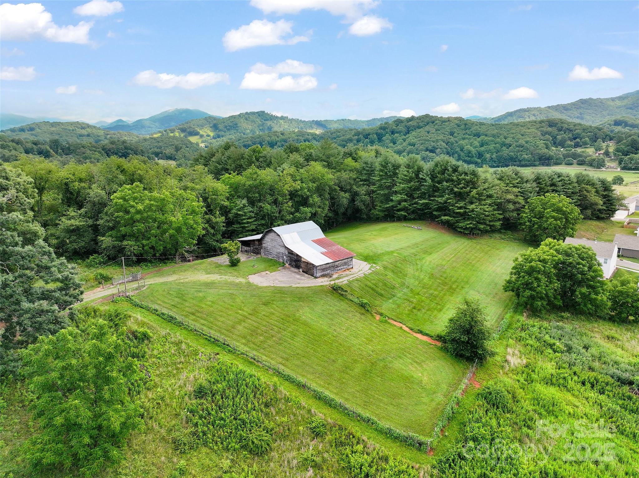 1.92-acre parcel located in the Town of Waynesville ETJ/East Waynesville Urban Residential Development Opportunity. Rare opportunity for residential development in one of WNC's most desirable & fast-growing areas. This property is ideally suited for a variety of housing types that align w/ the town’s vision for walkable, community-focused neighborhoods. Situated just minutes from downtown Waynesville, w/ easy access to shopping, dining, schools, & major highways. East Waynesville Urban Residential (EW-UR) – supports a mix of residential uses including single-family homes, townhomes, & small-scale multifamily (subject to town approval). Gentle pasture terrain w/ mountain views & mature trees. Public water to property & sewer available nearby (buyer to verify connection points and capacity). A clean slate for developers or investors! Whether you're envisioning a cluster of charming cottages, a row of modern townhomes, small-scale multifamily project or private residence w/barn.