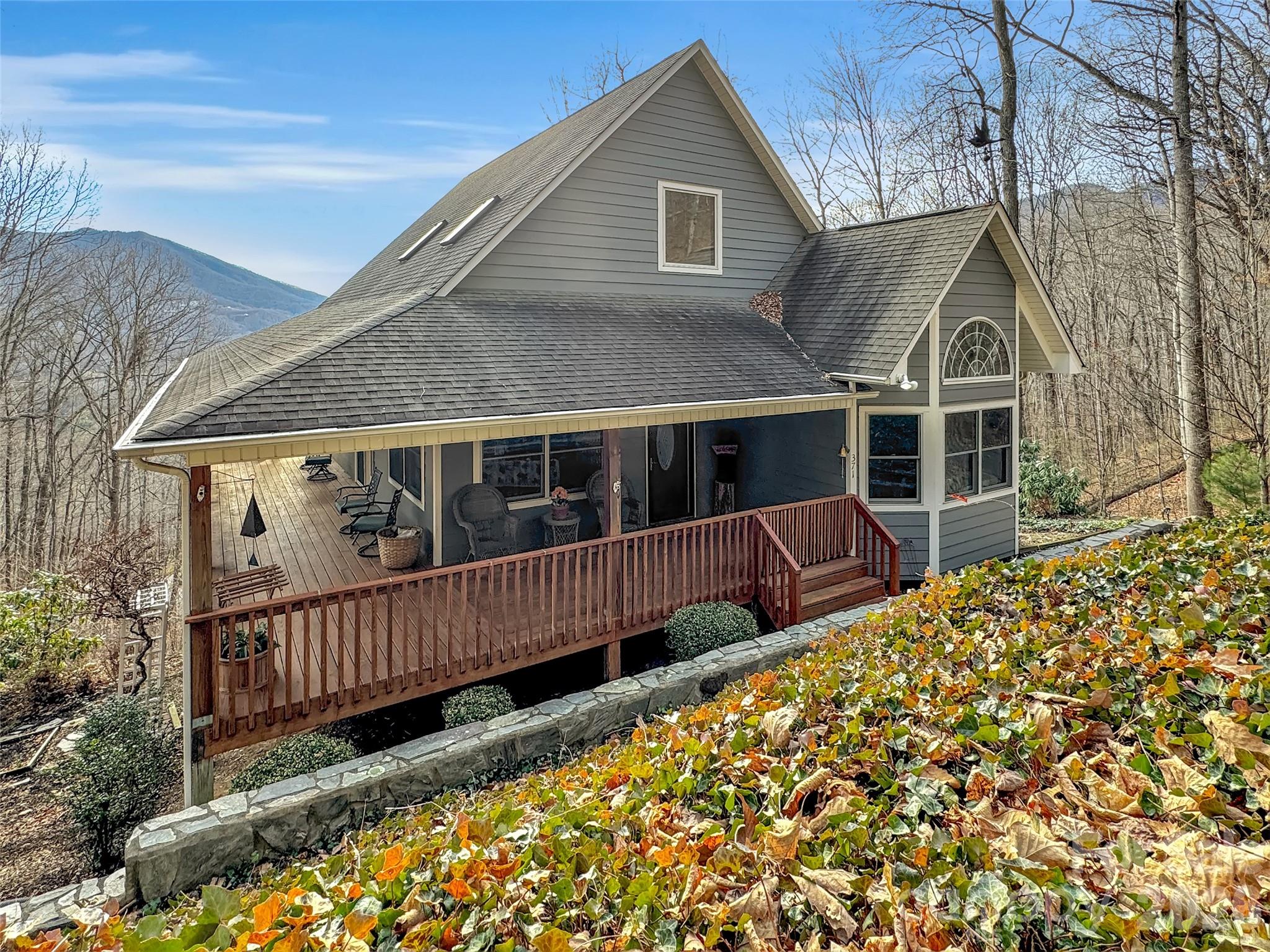 Experience the pinnacle of Blue Ridge living at 371 Falcon Ridge Drive, a turnkey mountain sanctuary where breathtaking long-range vistas take center stage. Nestled on 3 private acres, this immaculate 3-bedroom home offers the perfect blend of modern updates and rustic tranquility. Perched at an elevation of over 3,000 feet, the interior boasts an open and airy layout where windows frame the stunning mountain layers and bring the beauty of the outdoors inside. The inclusion of custom-made furniture ensures a one-of-a-kind design and is perfectly scaled to the space.

Thoughtful updates abound, including a newly updated primary bathroom for a spa-like experience and a brand-new gutter guard system for low-maintenance living. Sold furnished, this home is ready for a seamless move-in or to serve as your dedicated mountain escape. Whether you are sipping morning coffee on the large wrap-around deck, star-gazing at night, or watching the deer and turkey visitors that frequently roam the land, this home is a true sanctuary. Located in a highly sought-after neighborhood that values privacy and long-term residency (no short-term rentals allowed), you are just minutes away from the charming shops and dining of Waynesville, Hazelwood, and Sylva with the added benefit of no city taxes. This property offers the rare opportunity to own a secluded mountain retreat in a stable, established community.
