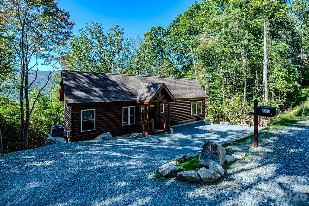 GREAT PRICE - RENTAL READY! Outstanding Log Cabin in Prime Beech Mountain Location – Views from Every Room. This beautifully crafted log cabin offers effortless one-step entry and convenient main-level living—all at an exceptional price for new construction. Fully furnished and move-in ready! Don't miss your chance to own a peaceful mountain retreat just minutes from Beech Mountain Club and the Beech Mountain Recreation Center. With easy access and ample parking, this home is an exceptional weekend getaway, full-time residence or vacation rental. Inside, you'll find quality finishes throughout, including hardwood floors, 9-foot ceilings, granite countertops, and stainless steel appliances. A free-standing wood-burning stove adds cozy mountain charm, complemented by central heat and air for year-round comfort. Enjoy long range mountain views from the expansive 250 sq ft back deck, built with durable, low-maintenance composite decking. The inviting covered front porch features vaulted beam details that add to the rustic appeal. Beech Mountain Club membership is available and can be activated with applicable fees. Membership offers access to an 18-hole golf course, tennis and pickleball courts, a 24-hour fitness center, kids’ day camp, slope-side clubhouse, swimming pool, and more. Whether you're seeking a serene second home or a full-time mountain lifestyle, this property is a must-see. Schedule your tour today!