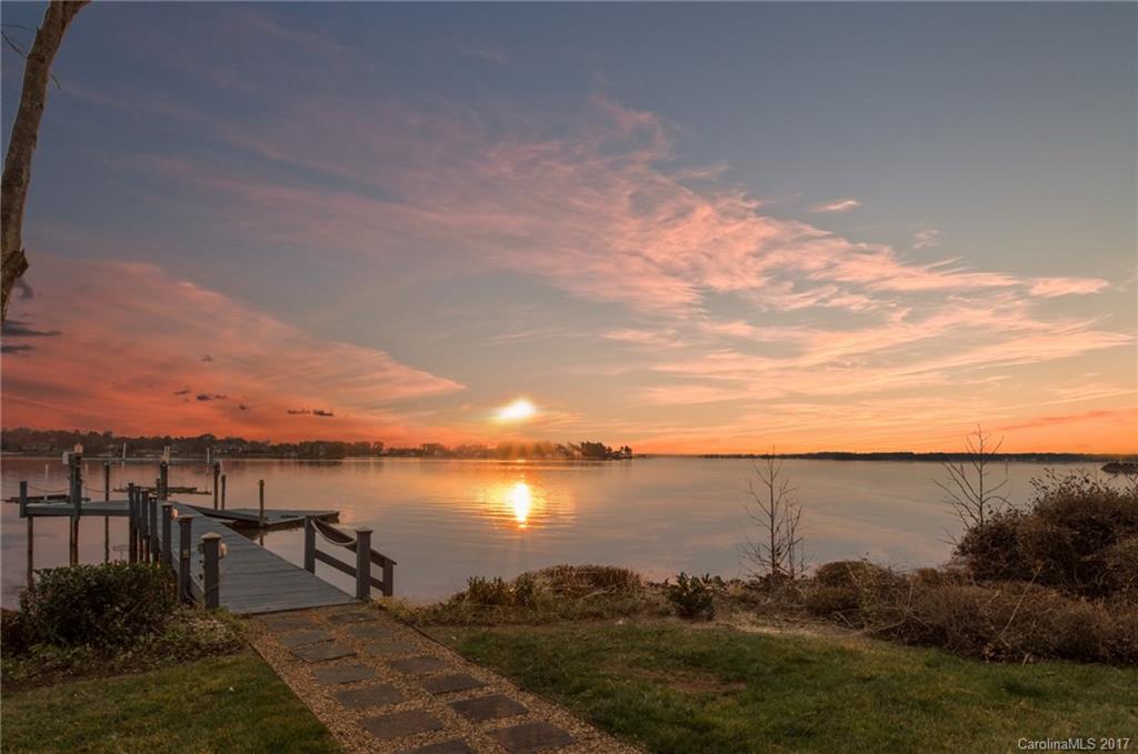 Stunning Lake Norman sunsets and a panorama of long-range, open views from this waterfront home with a dramatic design impact. Long, stone paver driveway leads to a private retreat setting. Open floorplan features walls of glass, huge round windows to soak in the lake & for great entertaining. Covered patio with hot tub & private pier has jet ski lifts. Home is in need of significant renovation- value is in the land. Also as MLS#3271064.