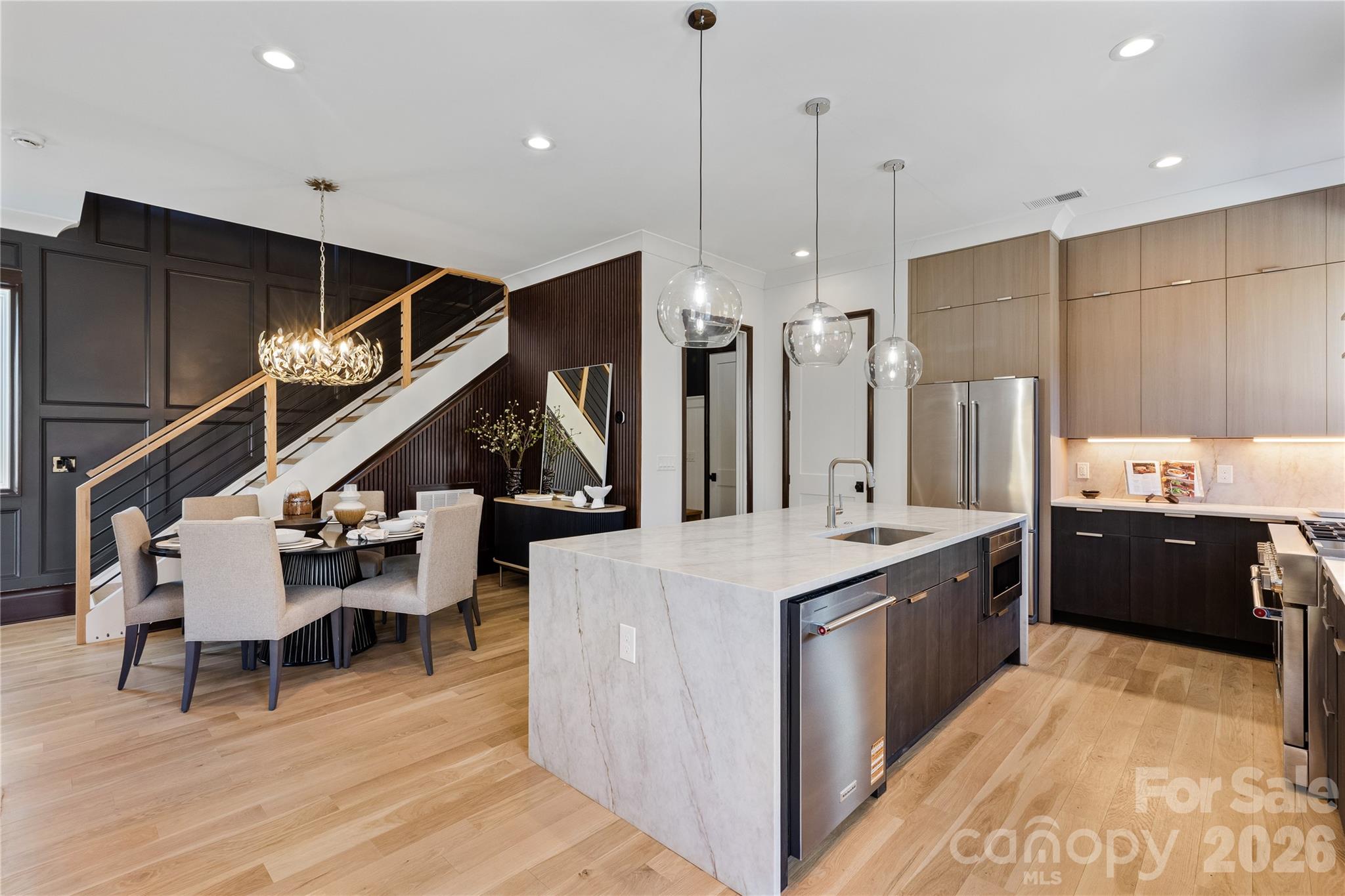 Welcome to 2117 Lombardy Circle, a refined luxury residence perfectly positioned between the charm of Dilworth and the elegance of Myers Park. Just moments from Freedom Park, this home offers the ideal blend of timeless design, modern comfort, and an unmatched Charlotte lifestyle.

From the moment you enter, thoughtful craftsmanship and elevated finishes set the tone. Site-built white oak floors, 10-foot ceilings, and abundant natural light create a warm, sophisticated atmosphere throughout the home. Every detail has been carefully selected to provide both beauty and everyday functionality.

The gourmet kitchen serves as the centerpiece of the home, featuring Taj Mahal quartzite countertops, custom cabinetry, and a spacious layout designed for effortless entertaining and daily living. The open living spaces offer a seamless flow while maintaining a sense of comfort and privacy.

Four spacious bedroom suites, each with a private bath, provide exceptional flexibility for family, guests, a home office retreat, or multi-generational living. Each suite is thoughtfully designed to offer its own private escape with luxurious finishes and generous space.

Enjoy the outdoors in a private backyard designed for relaxing evenings, entertaining, or simply taking in the Charlotte seasons. A two-car garage provides convenience and storage, while the low-maintenance design allows you more time to enjoy all that this location has to offer.

With Freedom Park trails nearby, and the best of Dilworth and Myers Park just outside your door, 2117 Lombardy Circle is a rare opportunity to experience elevated living in one of Charlotte’s most desirable neighborhoods.