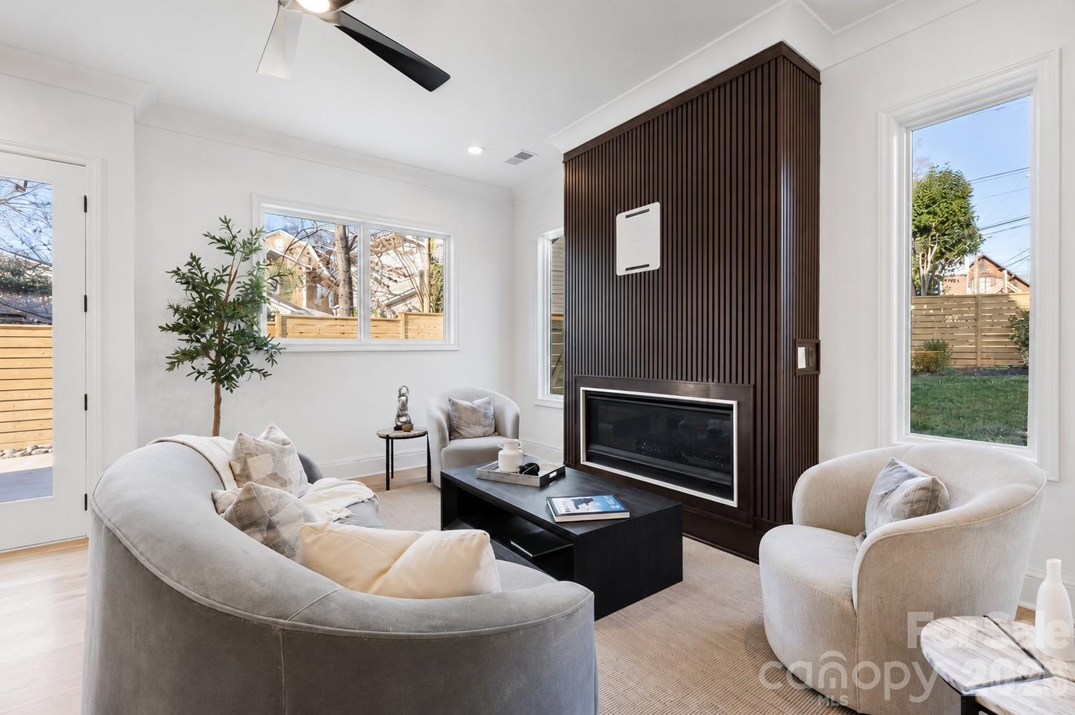 SELLER/BUILDER INCENTIVE: Up to $25,000 toward a buyer's interest rate buy-down or closing costs with an acceptable offer.

Welcome to 2117 Lombardy Circle, a custom-built modern residence ideally positioned between Dilworth and Myers Park, just moments from Freedom Park. Thoughtfully designed with exceptional craftsmanship and timeless finishes, this home offers the perfect balance of sophisticated entertaining, everyday comfort, and low-maintenance lock-and-leave living.

THE LAYOUT & FLEXIBILITY

Designed across three levels, this 2,920-square-foot residence features four private bedroom suites, each with its own en-suite bathroom, plus two additional half baths. The versatile third-floor loft offers exceptional flexibility as a media room, executive office, fitness studio, or private lounge.

CHEF'S KITCHEN & ENTERTAINING

Designed for both entertaining and everyday living, the gourmet kitchen showcases Taj Mahal quartzite waterfall countertops, custom cabinetry, premium stainless steel appliances, and an oversized island that flows seamlessly into the dining and living areas. Architectural details throughout include 10-foot ceilings, site-finished white oak hardwood flooring, custom millwork, designer accent walls, and oversized windows that fill the home with natural light.

PRIMARY SUITE RETREAT

The primary suite is a private sanctuary featuring a walk-out balcony and a spa-inspired bathroom with a custom wet room, freestanding soaking tub, luxury designer tile, and premium finishes.

CONVENIENCE & LOCATION

Additional features include a private rear patio, attached two-car garage, drop-zone mudroom, and thoughtfully designed low-maintenance outdoor spaces. Ideally located just minutes from Freedom Park, Uptown Charlotte, South End, Atrium Health, Novant Health, and the dining and shopping destinations along East Boulevard, this home offers exceptional convenience in one of Charlotte's most desirable neighborhoods.
