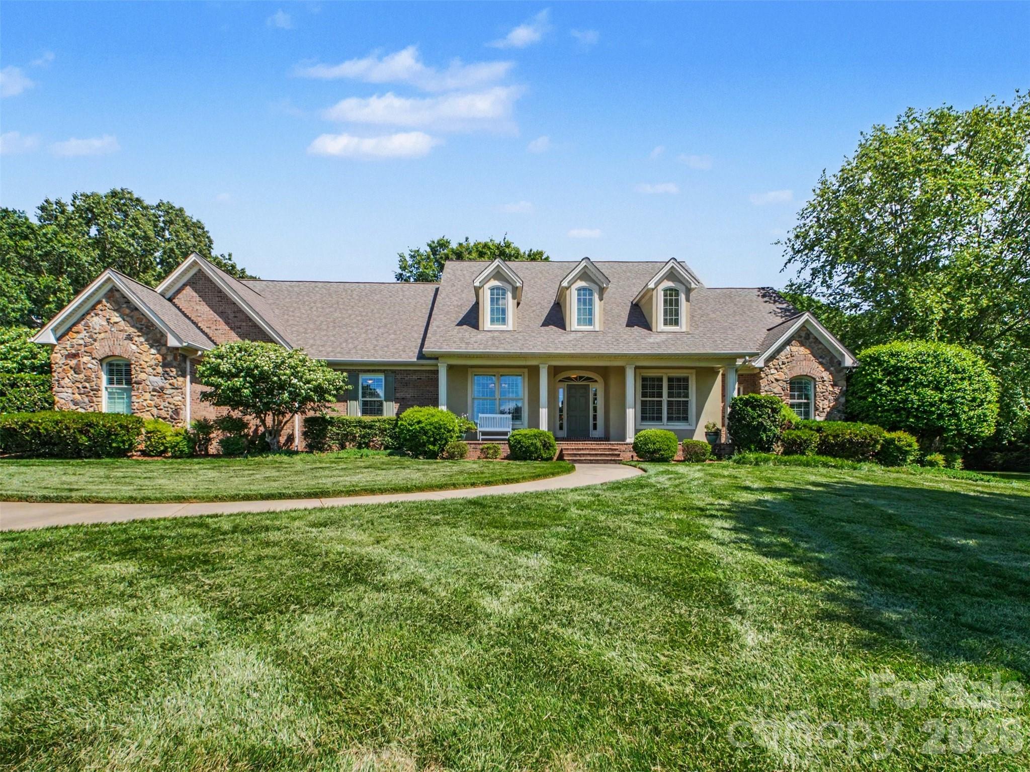 Rarely available Stone Gate subdivision home has everything you can imagine and MORE! Timeless French Country-inspired exterior with beautiful curb appeal, stone and brick accents, dormer windows, arched architectural details and a gracious covered front entry. A curved walkway, manicured lawn, and mature landscaping create a warm and elegant welcome. A thoughtful floor plan provides open concept spaces along with dedicated private spaces--truly the best of both worlds. For instance, enter into a spacious open concept living room and dining room with high ceilings, thick moldings, tall windows, and a fireplace. This is the perfect place for welcoming and entertaining friends and family. Then, there are two access points to a huge chef's kitchen that is open to a fabulous breakfast room with a wall of windows overlooking the back yard. A vaulted ceiling family room is adjacent to the kitchen and open to the breakfast bar which allows everyone to be connected but not on top of each other! Notice the stone fireplace and wall of built-in bookshelves. Off of the family room, there is a sunroom accessed by a sliding French door that allows a private space for reading, resting, or enjoying games with friends and families. Sellers added another fireplace to this room because they loved spending time here! On one end of the house, you will find a primary bedroom, spacious home office, and additional bedroom with en-suite bathroom. The primary bedroom has exterior French doors that lead to the patio. The primary bathroom has been updated with tile flooring and a large walk-in tile shower. Dual vanities, separate water closet, and whirlpool tub add to the amenities, and there is a spacious walk-in closet with built-in shelving accessed through the bathroom. Down the main hall, there is a perfectly placed half bath for guest use and a dedicated laundry/utility room with a sink, workspace, built-in ironing board, and plenty of space for laundry and crafts. Shut the door and hide the mess! There are two additional bedrooms with a Jack and Jill bathroom that has been thoughtfully remodeled. It has a large vanity with two sinks and sets of drawers for each bedroom. There is a door to the tub/shower/toilet space that allows privacy and functionality for multiple users. Upstairs, you will find a huge recreation room and additional bedroom. There is a built-in desk with bookshelves and plenty of square footage to be divided and used as you wish. There is also a half bath. Outside, there is a lovely circle driveway in the front in addition to a spacious driveway leading to a side-entry three car garage hidden from the street. There is additional concrete pad that can be used for play space or more parking. The back yard is so lovely--completely level with some trees for privacy--and provides a perfect place for a pool!  The patio has a fire pit and is accessed from the primary bedroom, breakfast room, and sun room. This home has been lovingly maintained and features a NEW ROOF in 2024, updated irrigation system w/ over 100 sprinkler heads, an invisible fence for pets, an encapsulated crawlspace, and Elfa closet systems in many of the closets. There are several accessibility features including a concrete entrance ramp in the garage, wide hallways, large door openings, and the majority of the living space all on one level! The sellers would pick the house up and move it if they could! If you are thinking about building, STOP! This house checks all of the boxes and is move-in ready!  Don't miss it!