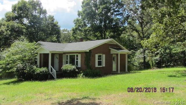 Beautiful 3.5 acre property 2/3 bedroom brick ranch with hardwood floors. Third bedroom is now being used as a dining room but can easily be converted to a bedroom. Large kitchen with breakfast bar and pine cabinets. Front and side porches. Detached barn/shop/garage. Needs some updating, but has great potential. Peaceful setting. BUFORD SCHOOLS!!