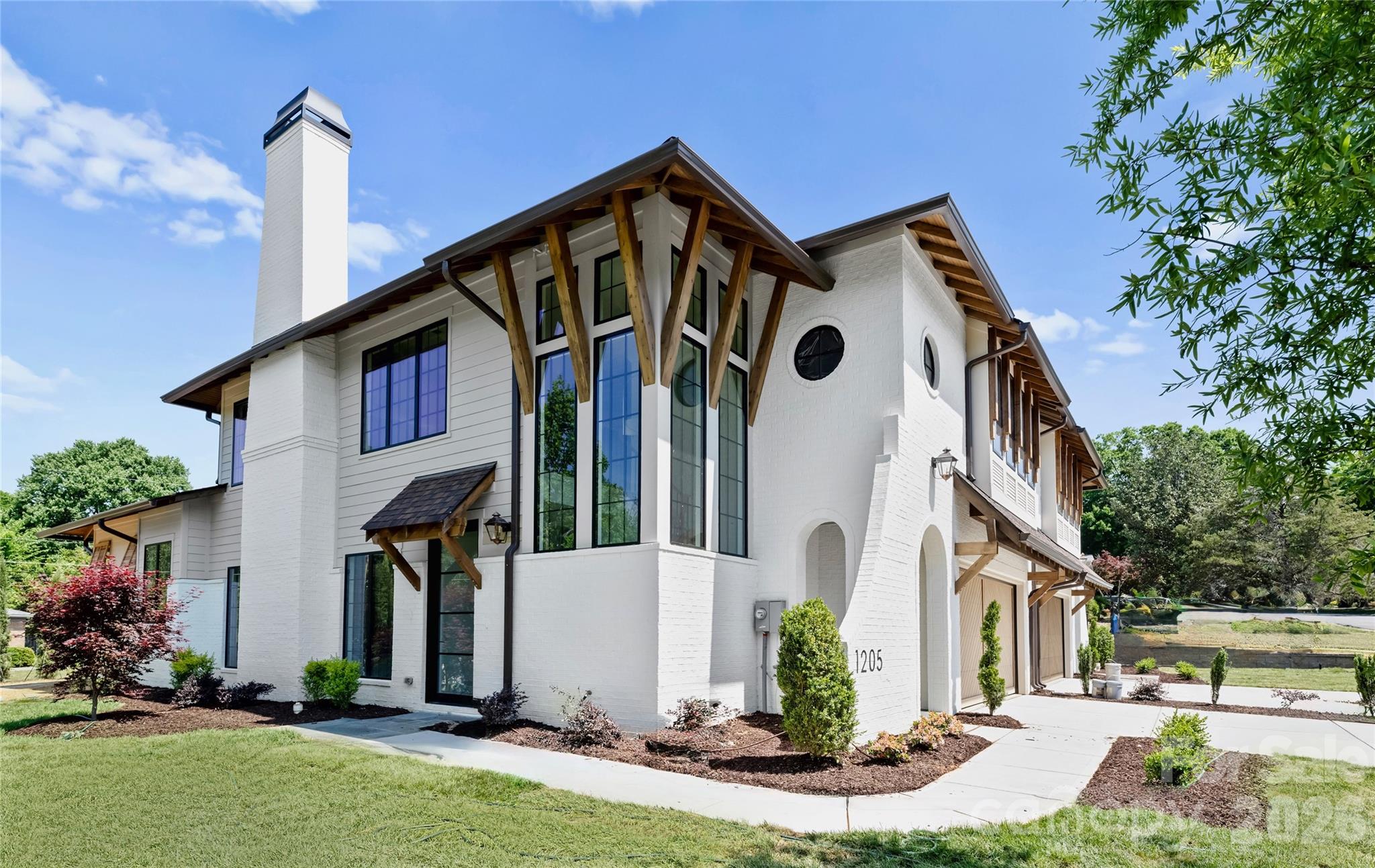 This Duet sets a new standard for elevated living, offering  4,300 square feet of thoughtfully curated space with a main-level primary suite and an expansive loft. Every inch of this home has been intentionally designed, delivering a level of finish and architectural detail rarely seen in its category.

From the moment you enter through the custom front door, the scale and craftsmanship are immediately apparent. Soaring ceilings, custom barrel vaults, arched openings, and exposed beams create a layered, architectural feel throughout, while engineered hardwoods, designer tile, and tailored lighting selections carry seamlessly from room to room. The living room fireplace anchors the main living space, adding warmth and dimension. The primary main level suite offers a true retreat with a 12’ ceiling and a spa-inspired bath, while spacious secondary bedrooms and a large loft provide flexibility for everyday living.

The kitchen features custom two-tone cabinetry from tile to ceiling, custom hood, quartz countertops, fluted island, and a premium JennAir appliance suite, complemented by a functional scullery. A 15’x10’ Pella sliding glass door system opens to the covered rear lanai with a fireplace, extending the living space outdoors and creating the ideal setting for year-round entertaining.

Additional highlights include Pella high-efficiency windows, an oversized garage with 18' custom wood doors, and thoughtfully integrated energy-efficient features including dual HVAC systems and Rinnai tankless hot water.

This is a rare opportunity to own a home where architecture, scale, and finish meet in desirable Ashbrook.