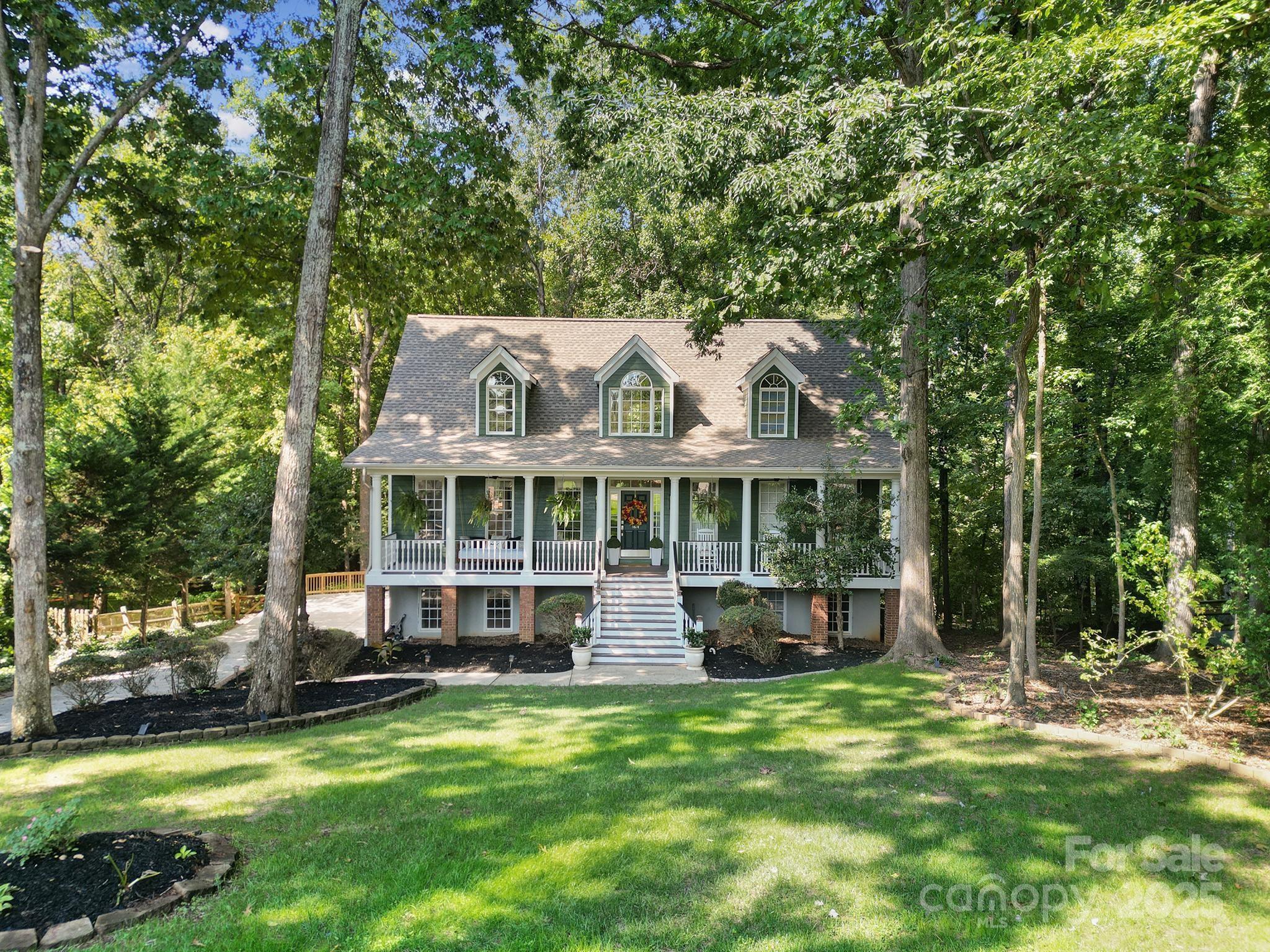 This beautiful basement home is perfectly set on a picturesque lot in one of Fort Mill’s most desirable communities. Blending timeless Southern charm with modern updates, it features fresh interior paint, new flooring throughout, and thoughtfully refreshed kitchen and bath spaces that create a bright, inviting atmosphere. A wide front porch welcomes you inside, where the main level includes a comfortable primary suite offering ease and privacy. Upstairs, an additional bedroom with generous proportions could easily serve as a second primary suite, ideal for guests, in-laws, or multi-generational living. The finished basement adds exceptional versatility with open areas for entertaining, a home office, gym, or media space, along with excellent storage options. Outdoors, mature landscaping and a private backyard provide a peaceful setting for gatherings, gardening, or quiet relaxation. Located close to top-rated Fort Mill schools, shopping, dining, and major highways easily accessible. This home offers the perfect balance of comfort, convenience, and character. With its flexible floor plan, thoughtful updates, and inviting curb appeal.