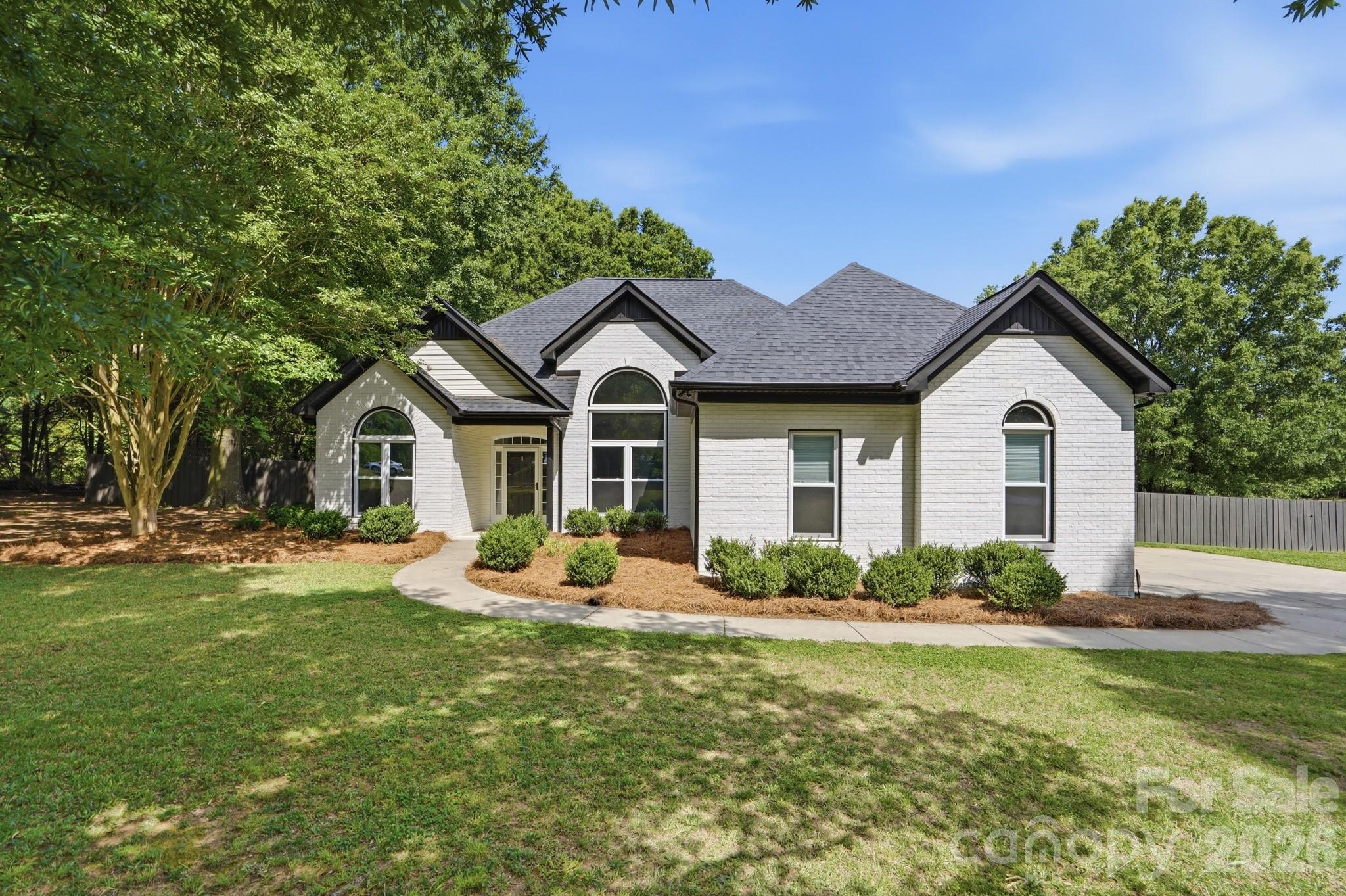 Gorgeous turn-key home on 1.37 acres in Monroe! You will love the privacy of the large corner lot, with the home set back from the road and surrounded by mature shade trees. Inside, the soaring ceilings and large windows throughout the main level bring an airy brightness and flexibility to the open floor plan. The kitchen is breezy and functional, opening onto the breakfast nook which overlooks the back yard. The primary suite is big and peaceful, with a beautiful en-suite bath and large walk-in closet, and two additional bedrooms plus another full bath offer plenty of space for family and guests. There is a large, finished bonus room with half bath and wet bar over the two-car attached garage. Outside, you'll find a large patio for grilling and outdoor meals, plus an above-ground pool with deck, enclosed in a safety fence separate from the rest of the privacy-fenced backyard. Peace of mind for the big ticket items: HVAC was replaced in 2024 and roof was replaced in 2025. Don't wait, come see it today!